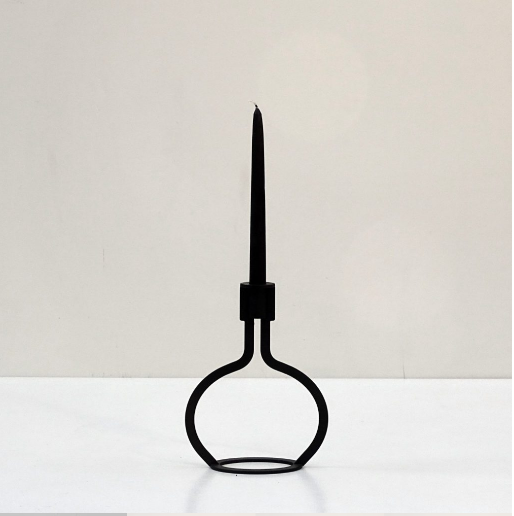 THE BOTTLE candlestick designed by Peter van de Water, featuring a sleek industrial steel design with a black matte finish.