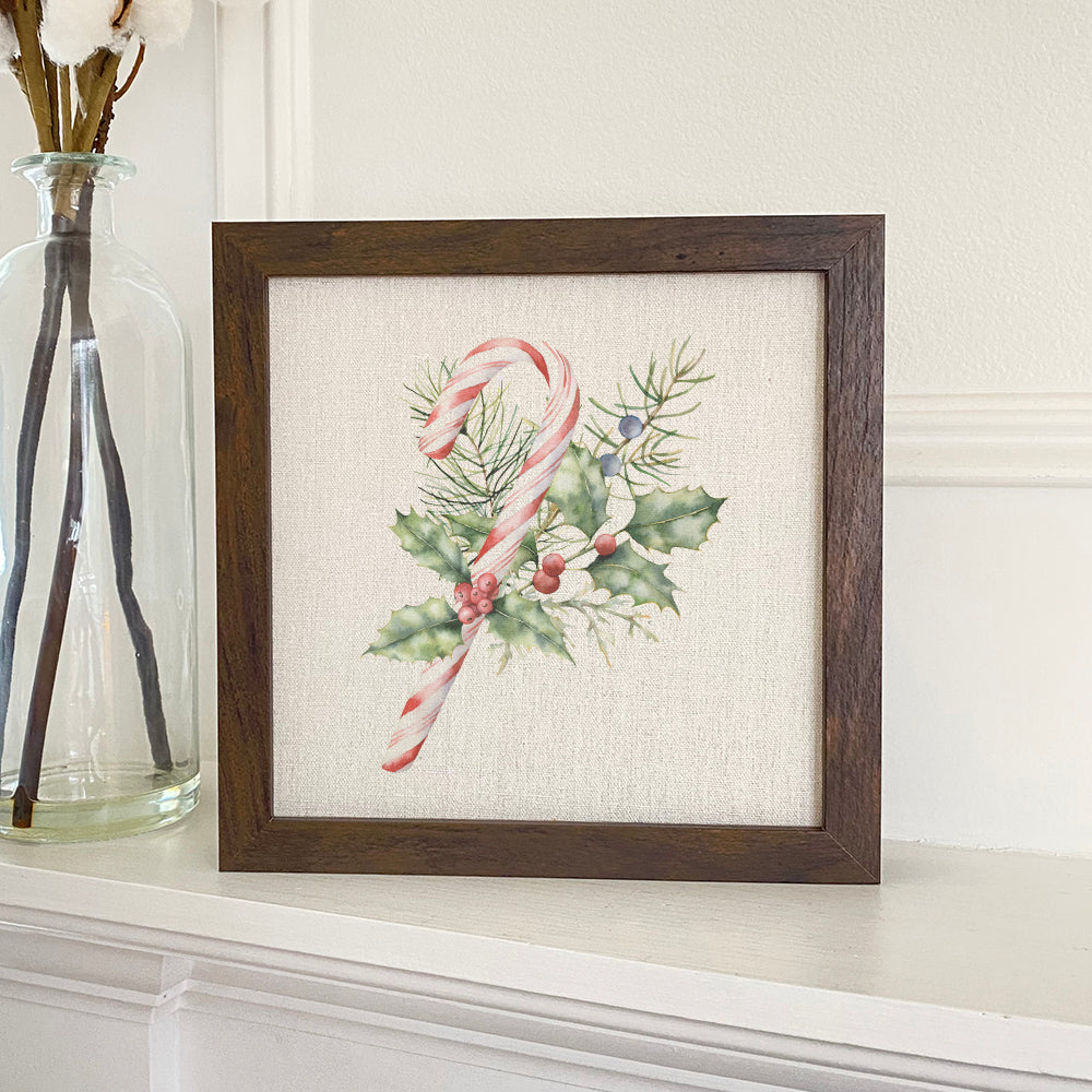 Candy Cane with Holly framed sign featuring a wood frame and eco-friendly printing on a linen-look background.