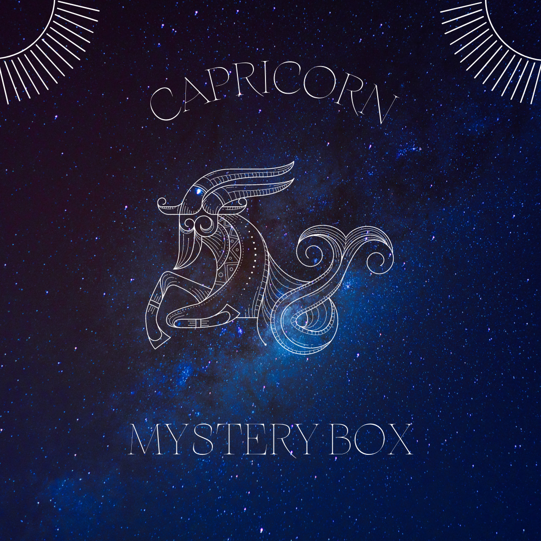 A beautifully arranged Capricorn Mystery Box featuring various crystals, sage, and Palo Santo, designed for astrological balance and growth.