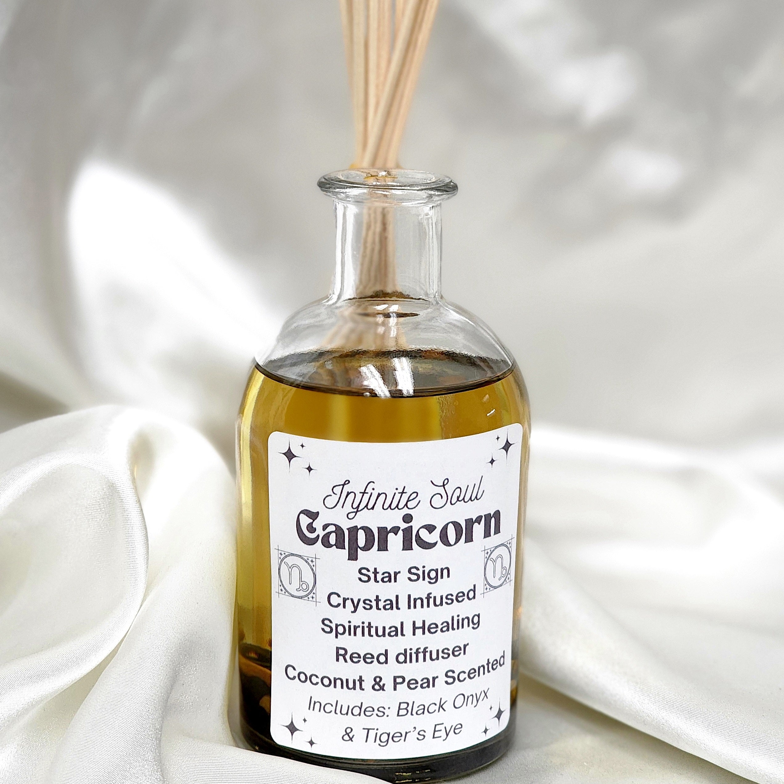 Capricorn Star Sign Crystal Infused Reed Diffuser featuring Coconut and Pear scent with Black Onyx and Tigers Eye crystals.