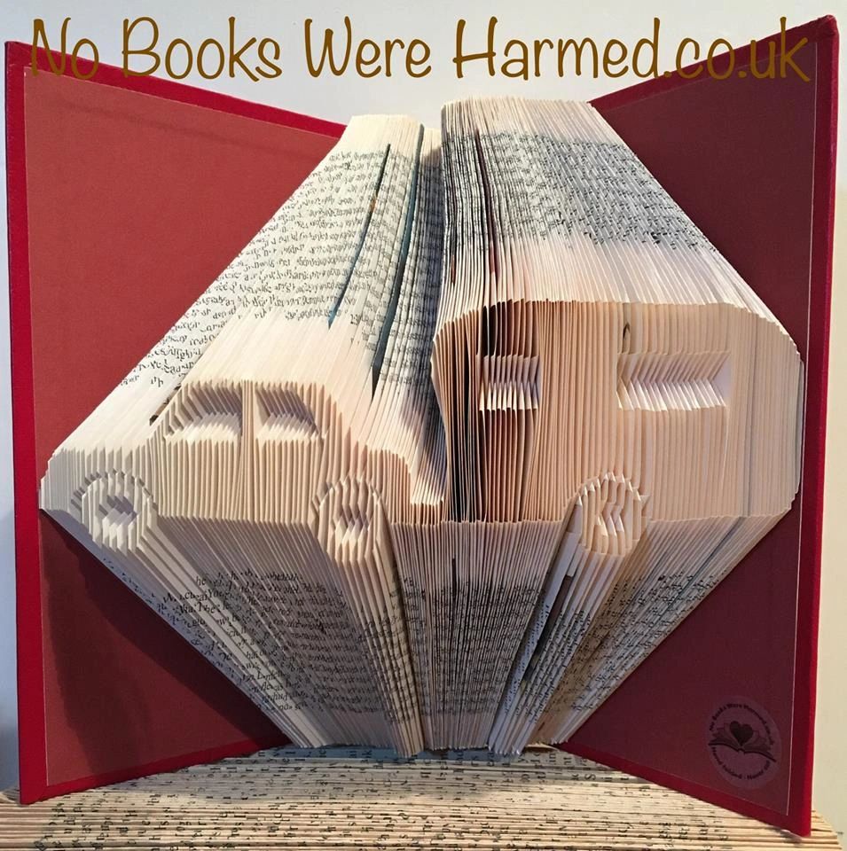 Hand folded book art featuring a Car & Caravan design, showcasing intricate folds and unique colors from vintage books.