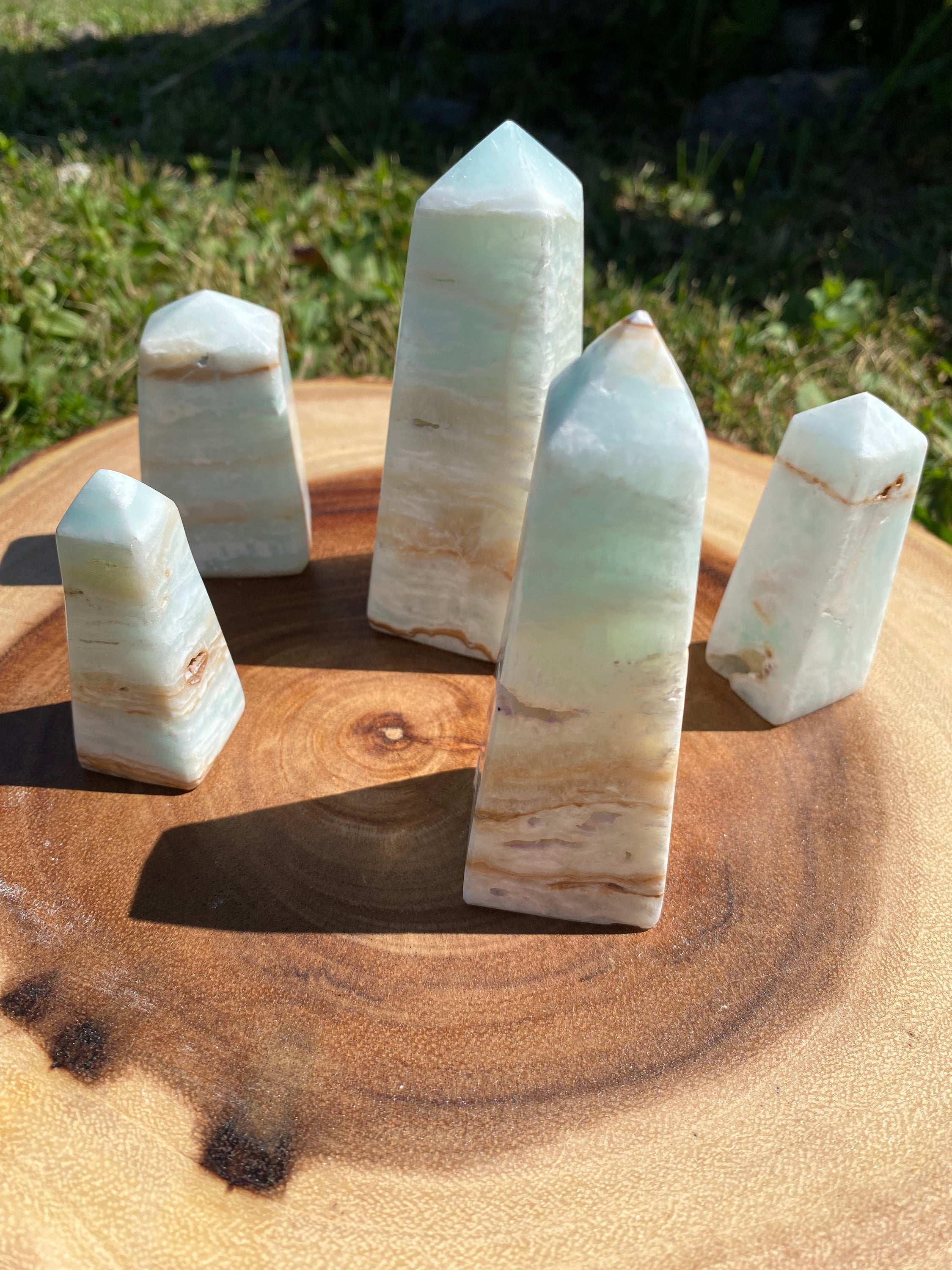 A beautifully crafted Caribbean Calcite Obelisk showcasing vibrant blue, green, and yellow colors, symbolizing tranquility and positive energy.