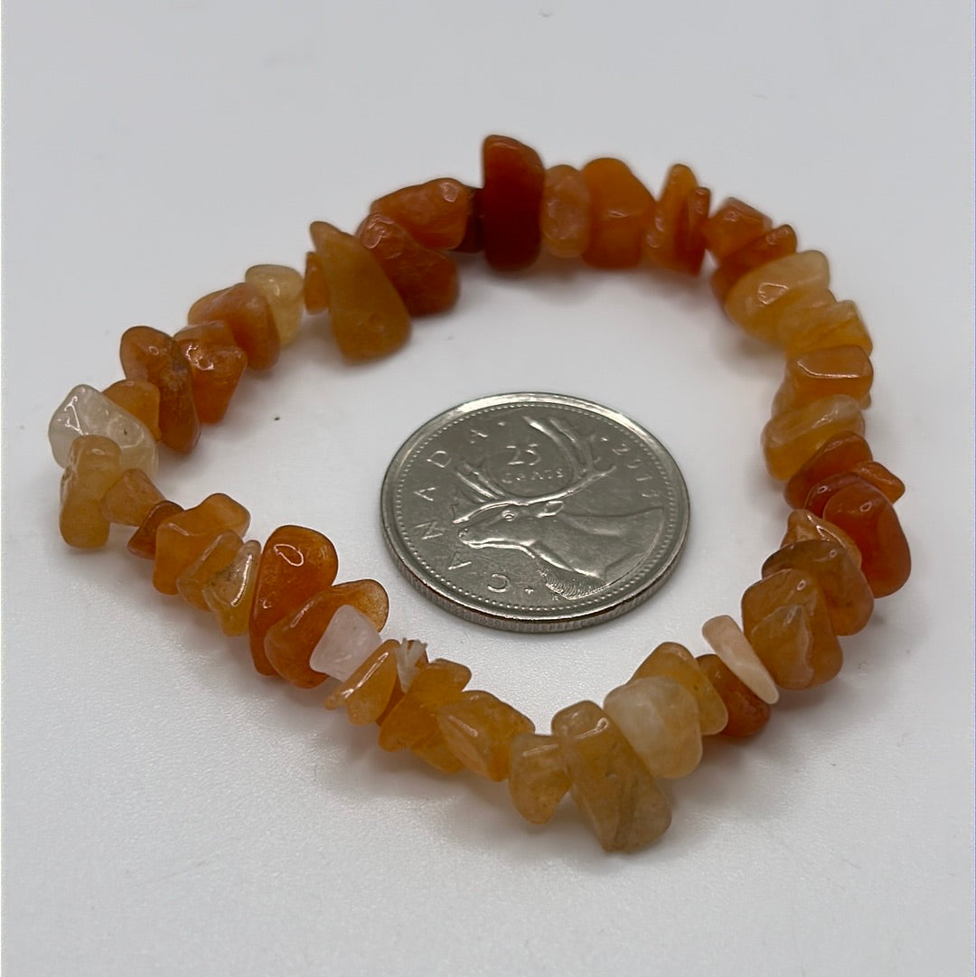 A stretchable bracelet made of vibrant carnelian chips in red and orange hues, symbolizing motivation and self-esteem.