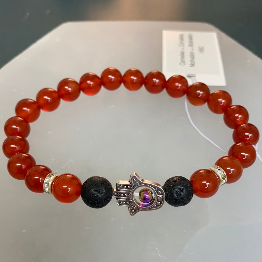 A stretchable Carnelian Hamsa Bracelet featuring vibrant carnelian stones, lava stone, and a protective hamsa hand symbol.