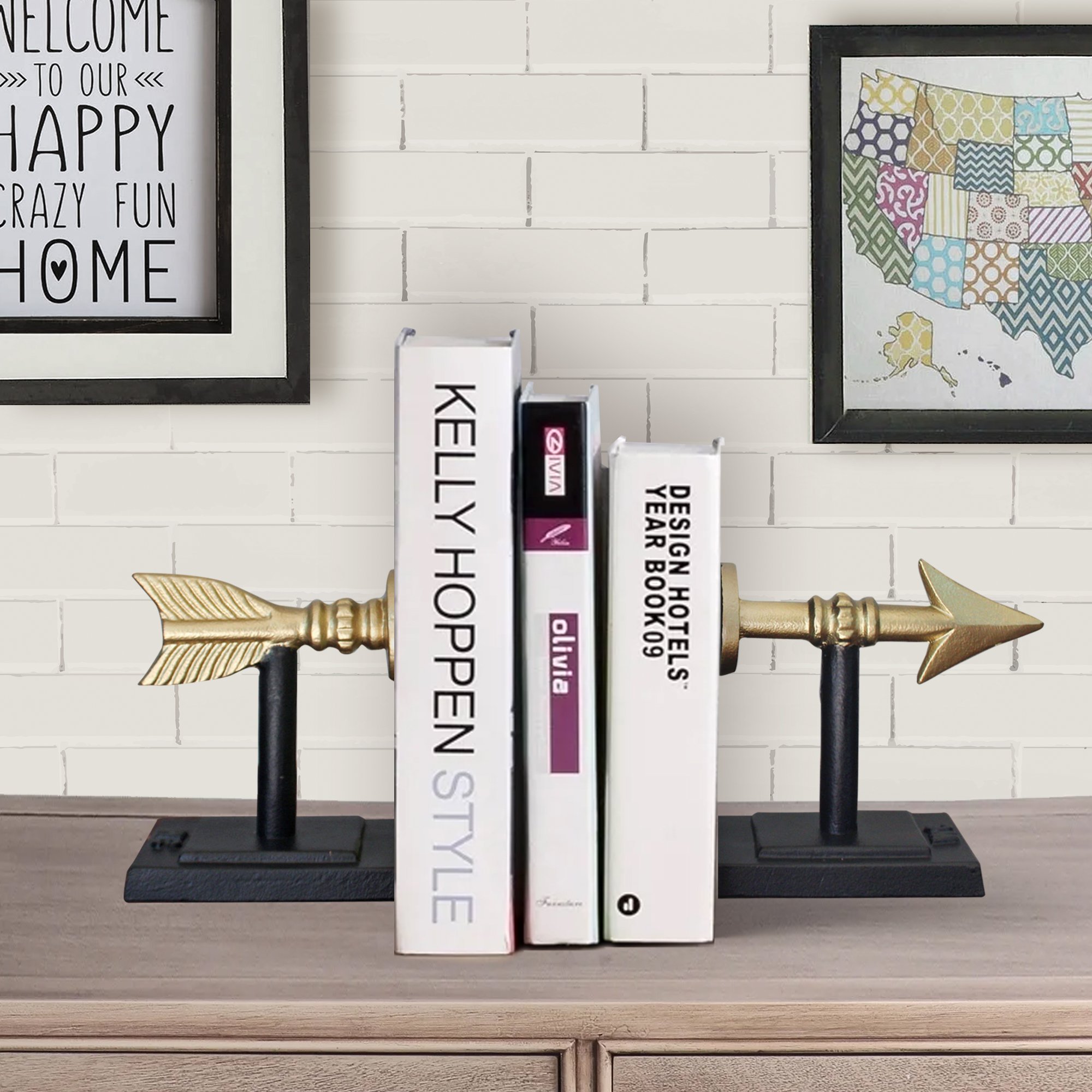 Stylish cast iron arrow bookends in gold and black, measuring 7 inches tall, elegantly holding books on a shelf.