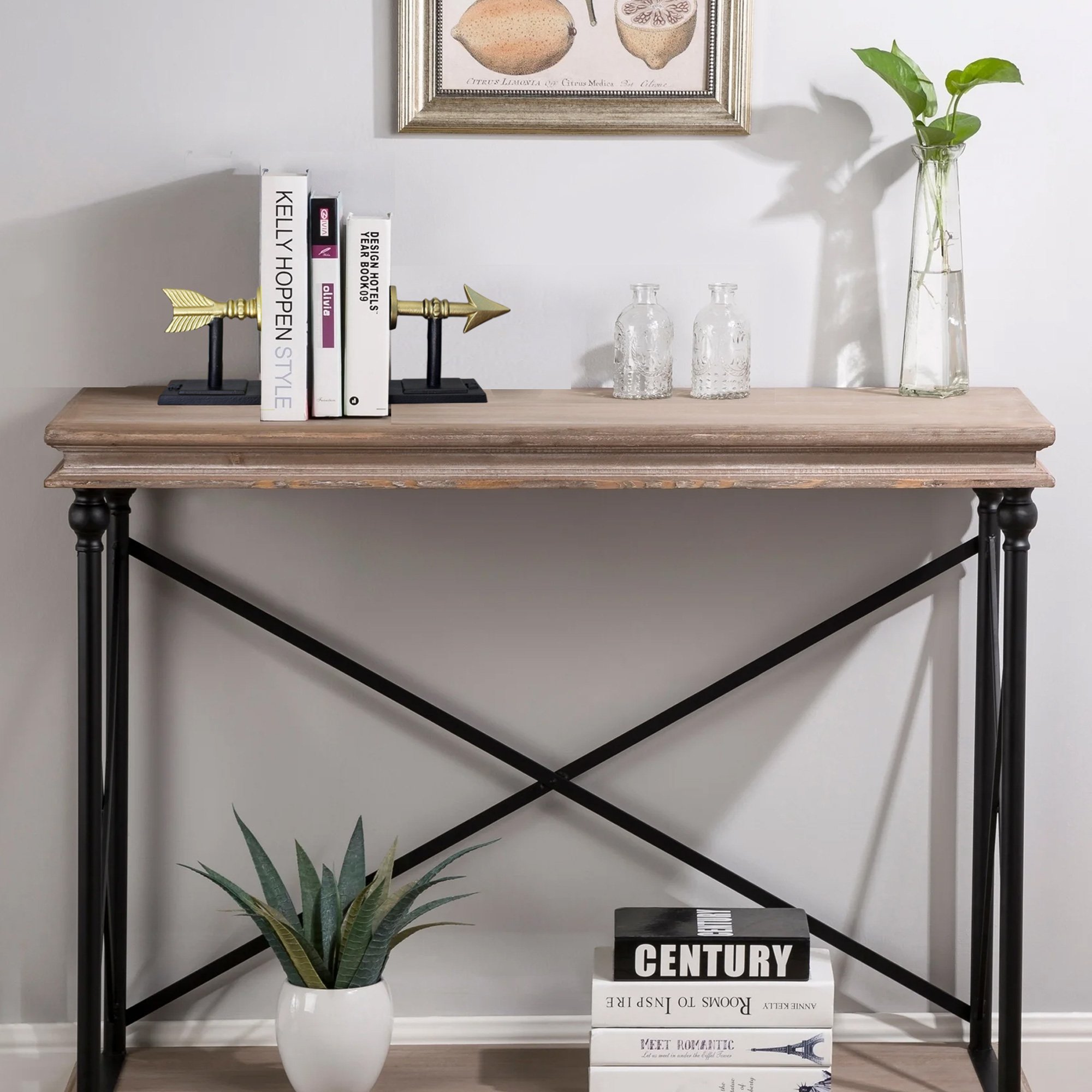 Stylish cast iron arrow bookends in gold and black, measuring 7 inches tall, elegantly holding books on a shelf.