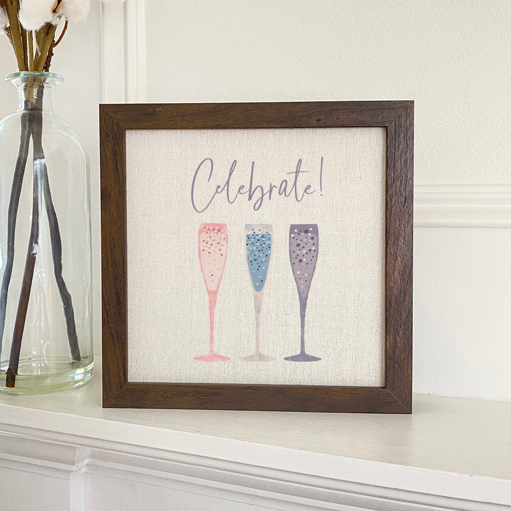 Celebrate Champagne framed sign with a linen-look background and walnut or white-washed frame options.