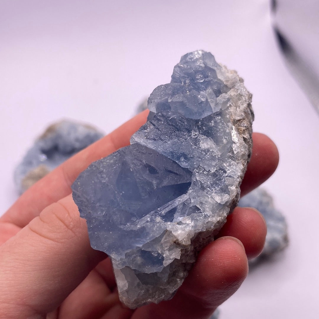 A beautiful Celestite geode chunk showcasing its vibrant blue color and natural crystal formations.