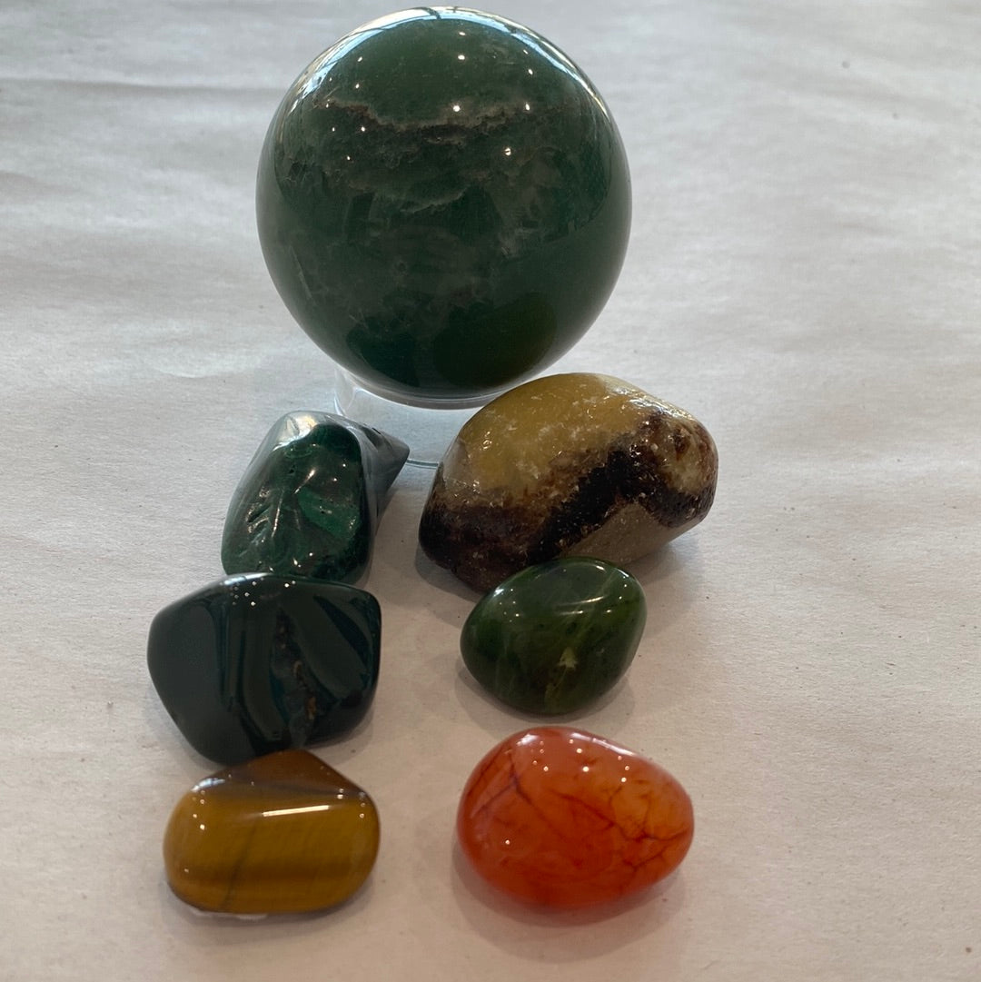 Change Maker Bundle featuring Carnelian Free Form and various healing stones in a velvet bag.