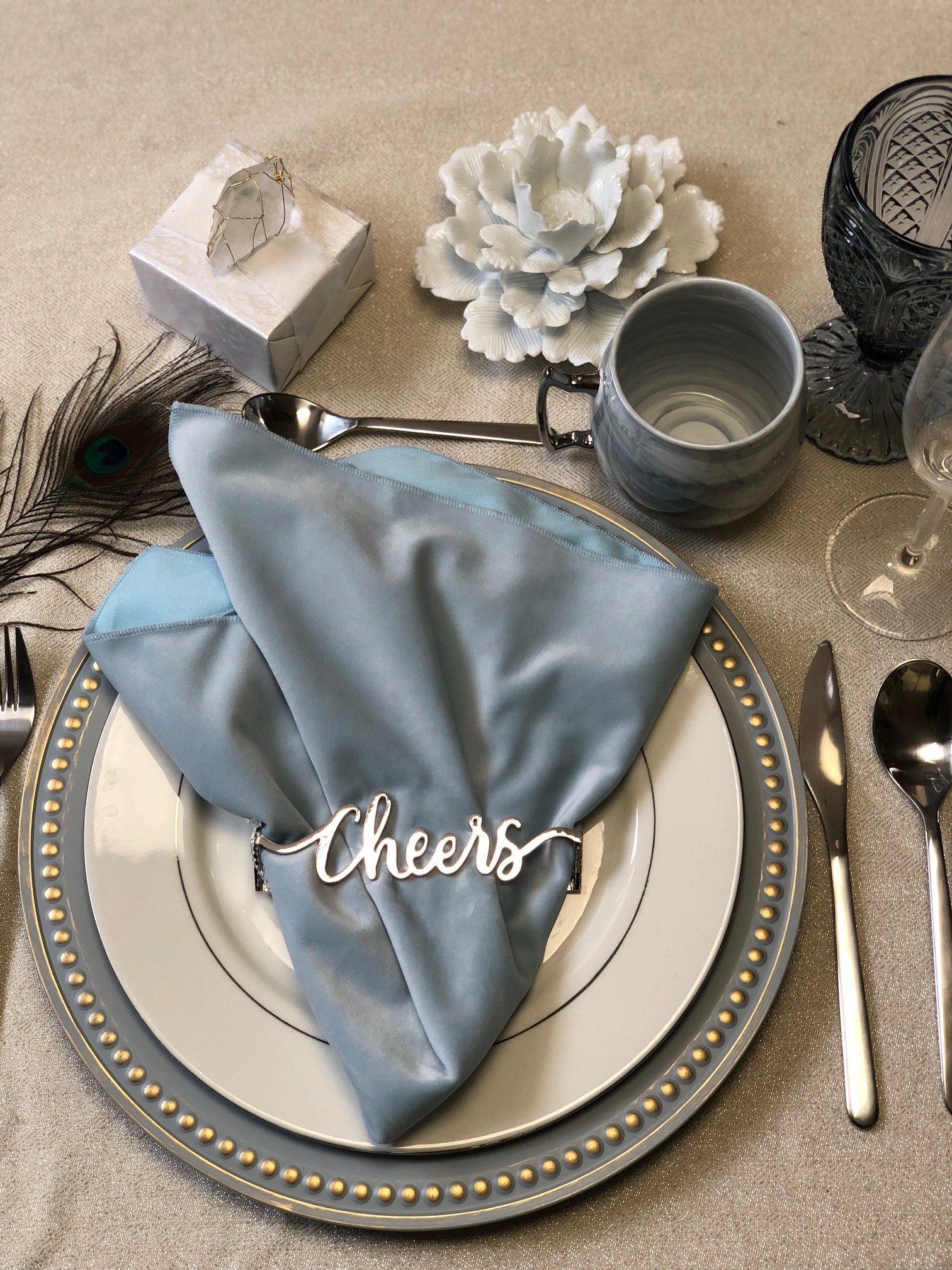 Cheers Napkin Wrap in shiny silver, elegantly designed for modern dining settings.