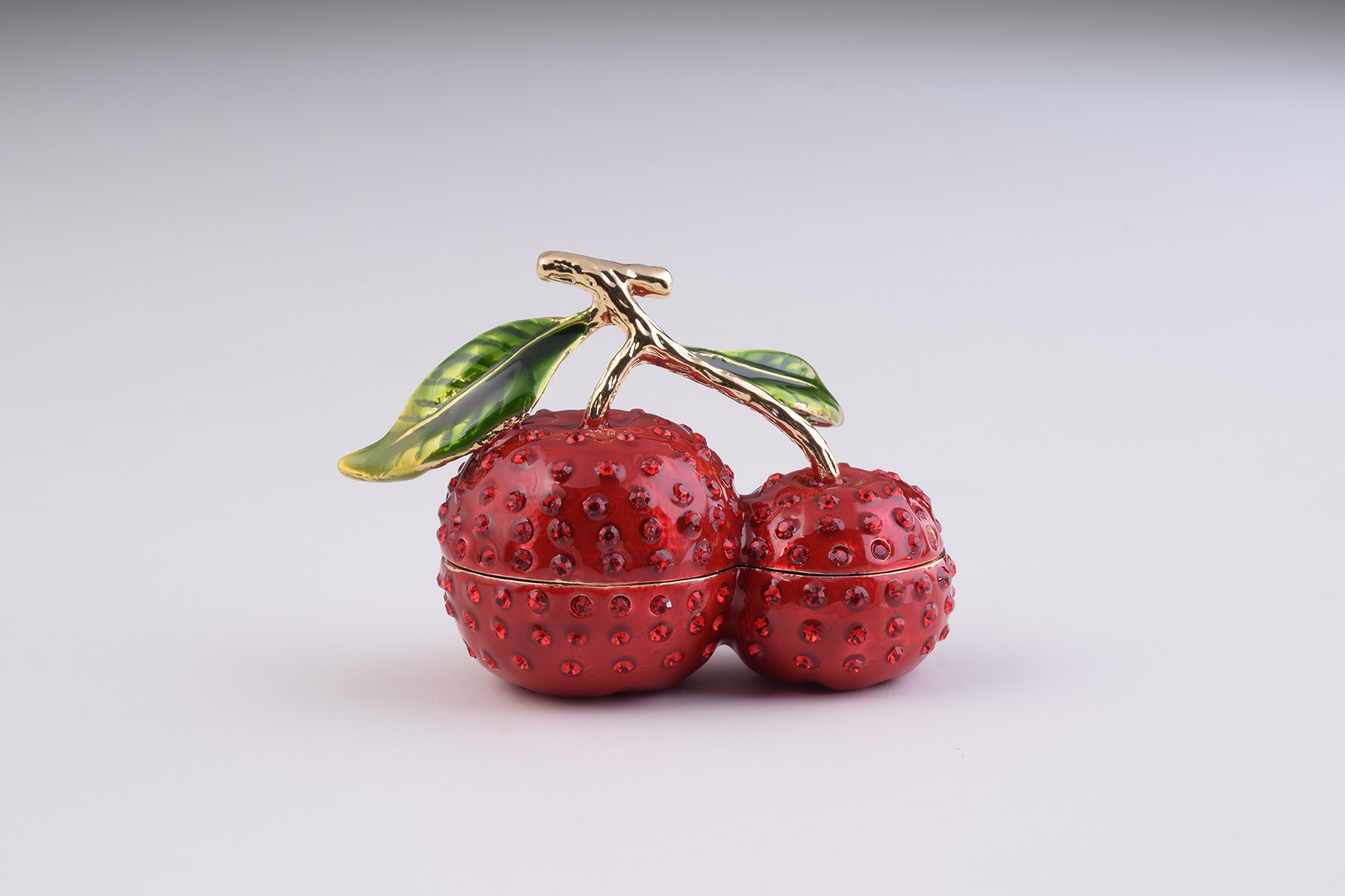 A beautifully handcrafted Cherry Trinket Box with enamel finish and Austrian crystals, featuring a secure magnetic closure and luxurious gold or silver plating.