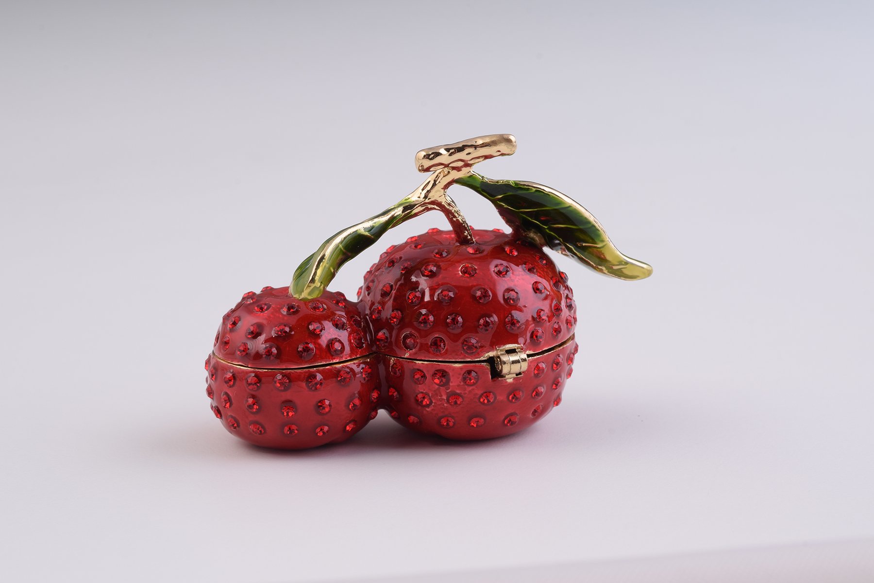 A beautifully handcrafted Cherry Trinket Box with enamel finish and Austrian crystals, featuring a secure magnetic closure and luxurious gold or silver plating.