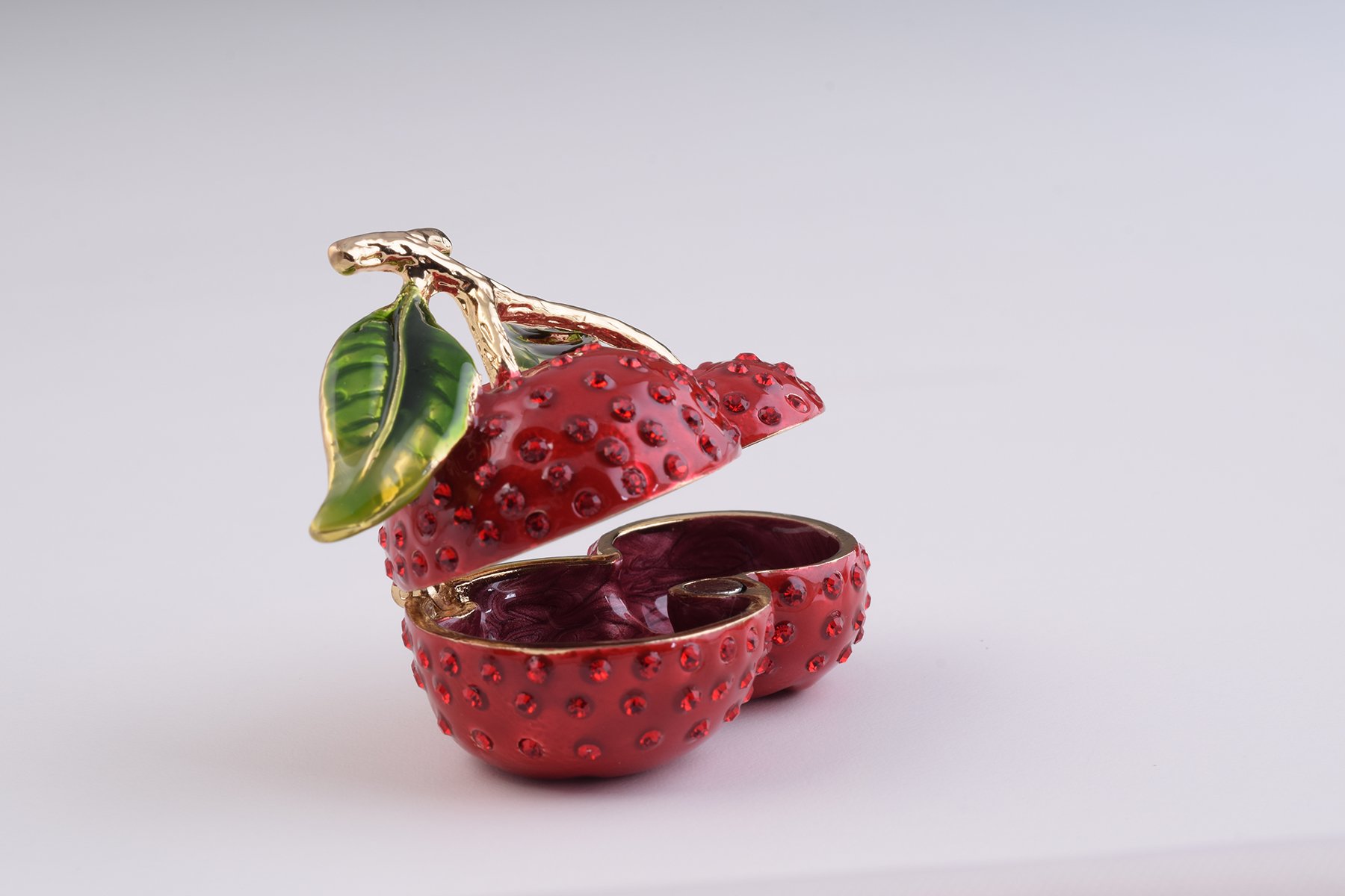 A beautifully handcrafted Cherry Trinket Box with enamel finish and Austrian crystals, featuring a secure magnetic closure and luxurious gold or silver plating.