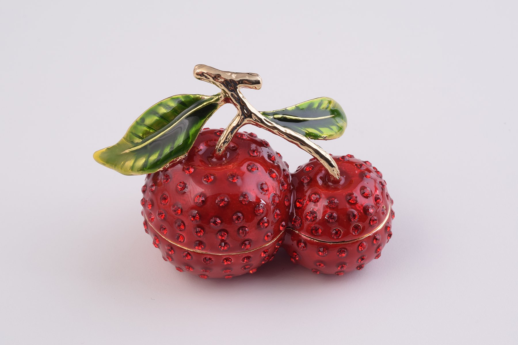 A beautifully handcrafted Cherry Trinket Box with enamel finish and Austrian crystals, featuring a secure magnetic closure and luxurious gold or silver plating.