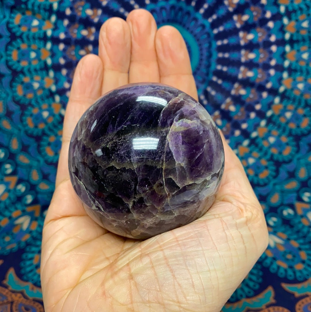 Chevron Amethyst Sphere #4, a 2.5-inch diameter crystal with banded purple and white patterns, weighing 385 grams.