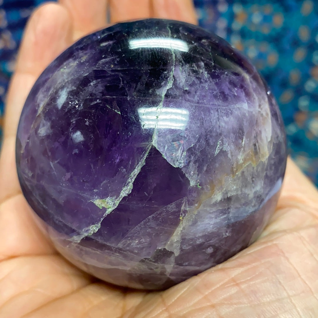 Chevron Amethyst Sphere #5, a 2.5-inch diameter crystal with unique banded patterns, showcasing its purple and white hues.