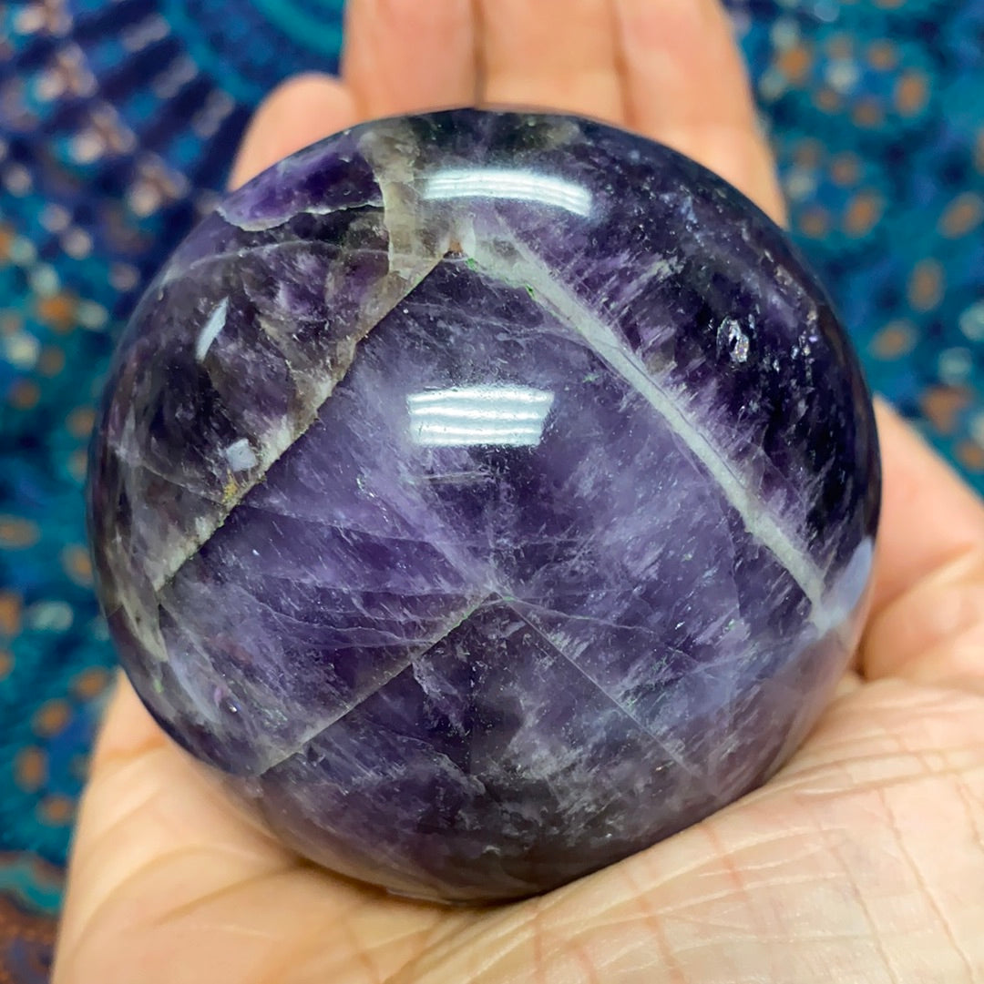 Chevron Amethyst Sphere #6, a beautiful banded crystal measuring 2.5-3 inches in diameter, showcasing its unique patterns and calming energy.