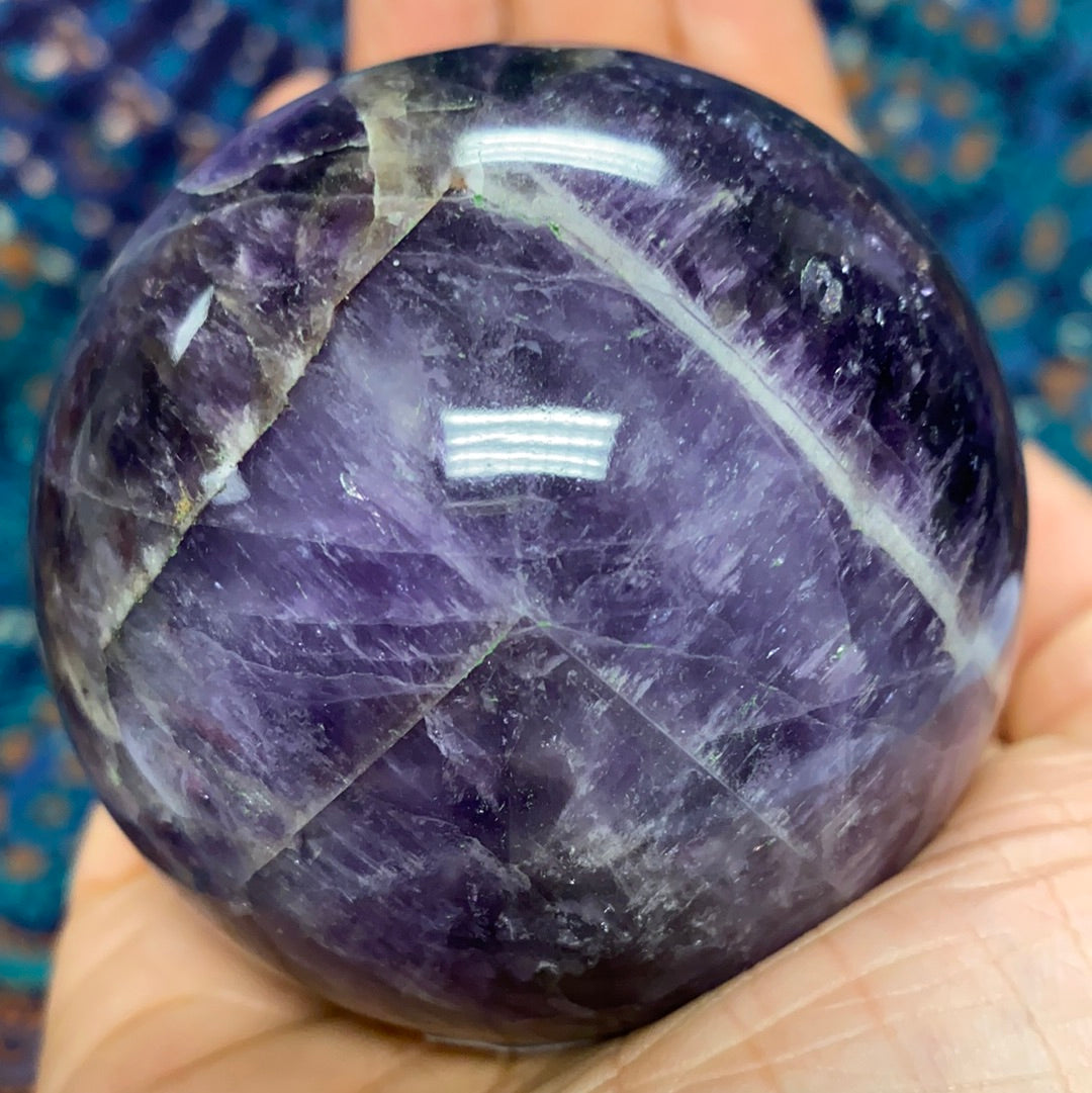 Chevron Amethyst Sphere #6, a beautiful banded crystal measuring 2.5-3 inches in diameter, showcasing its unique patterns and calming energy.