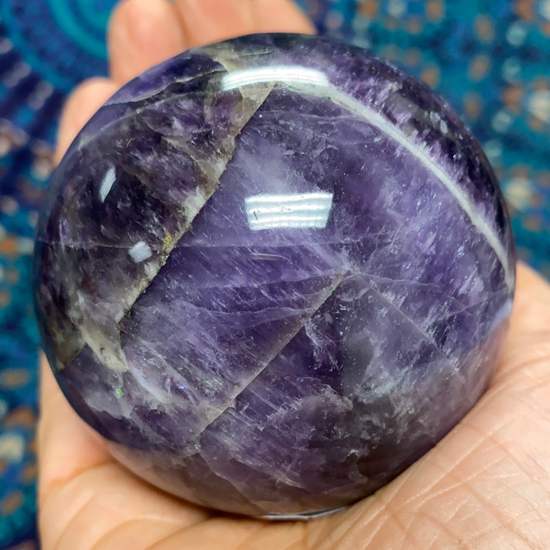 Chevron Amethyst Sphere #6, a beautiful banded crystal measuring 2.5-3 inches in diameter, showcasing its unique patterns and calming energy.