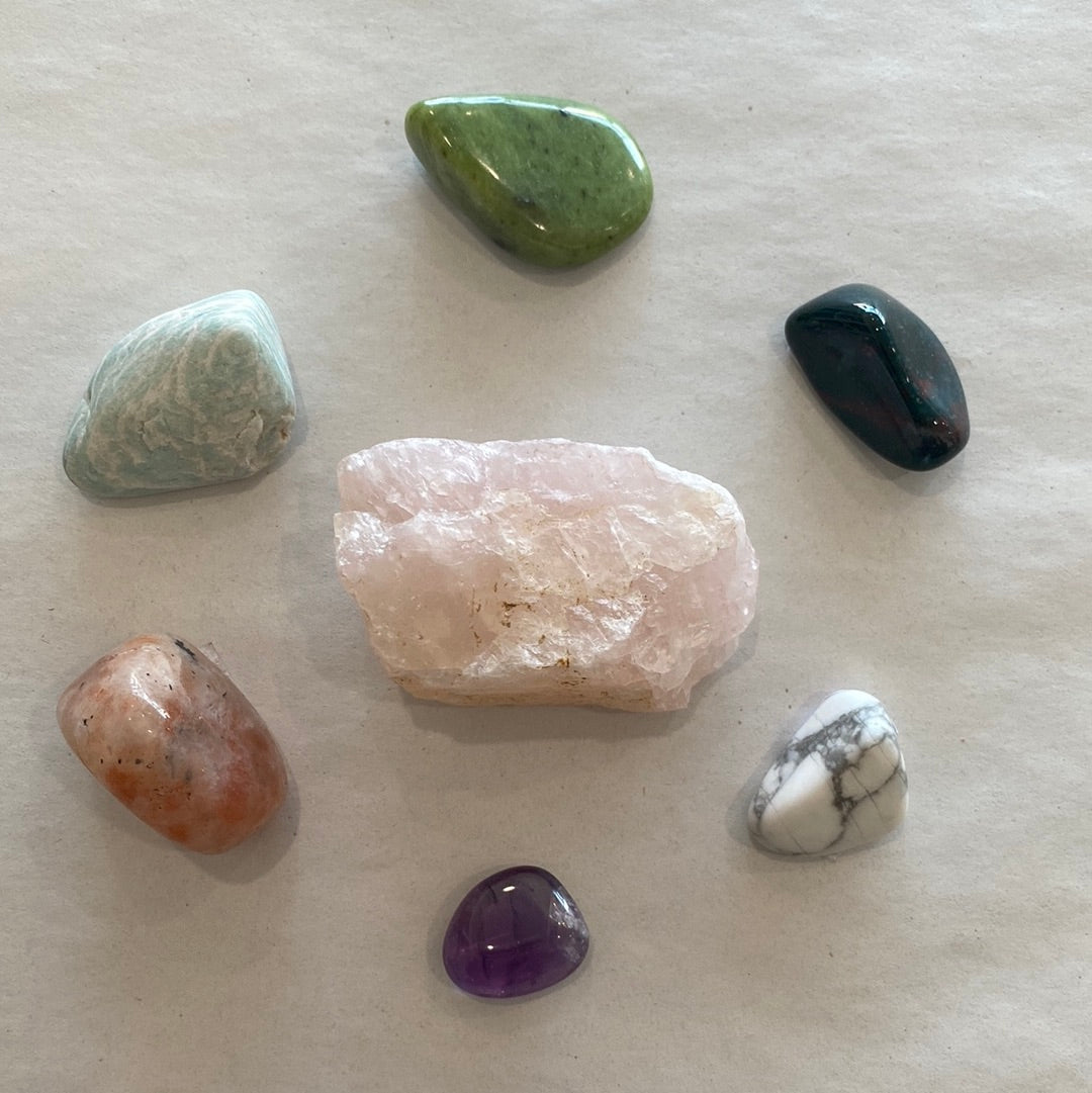 Chill Vibes Anxiety Bundle featuring various tumbled stones including Rose Quartz, Bloodstone, Sunstone, Amethyst, Howlite, Nephrite Jade, and Amazonite, beautifully arranged.