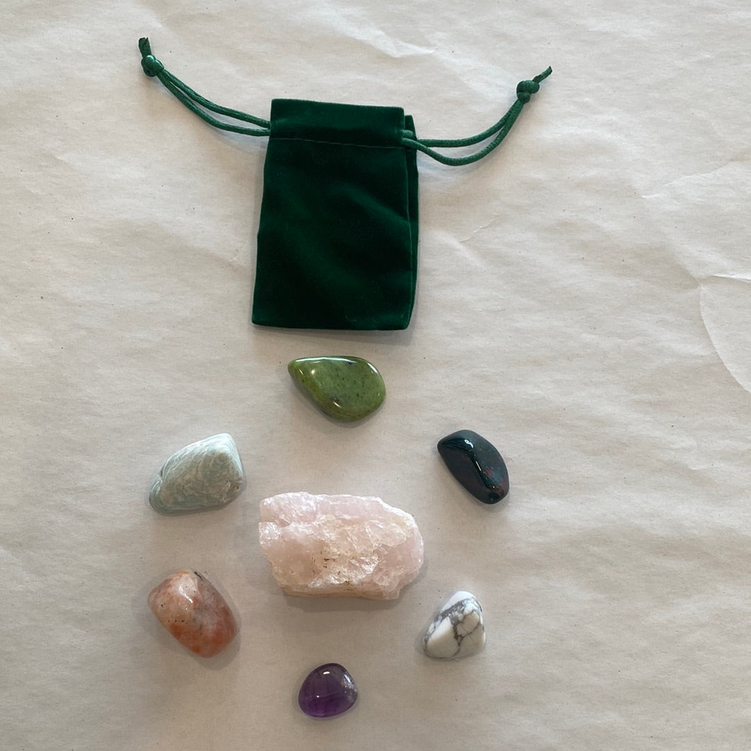 Chill Vibes Anxiety Bundle featuring various tumbled stones including Rose Quartz, Bloodstone, Sunstone, Amethyst, Howlite, Nephrite Jade, and Amazonite, beautifully arranged.