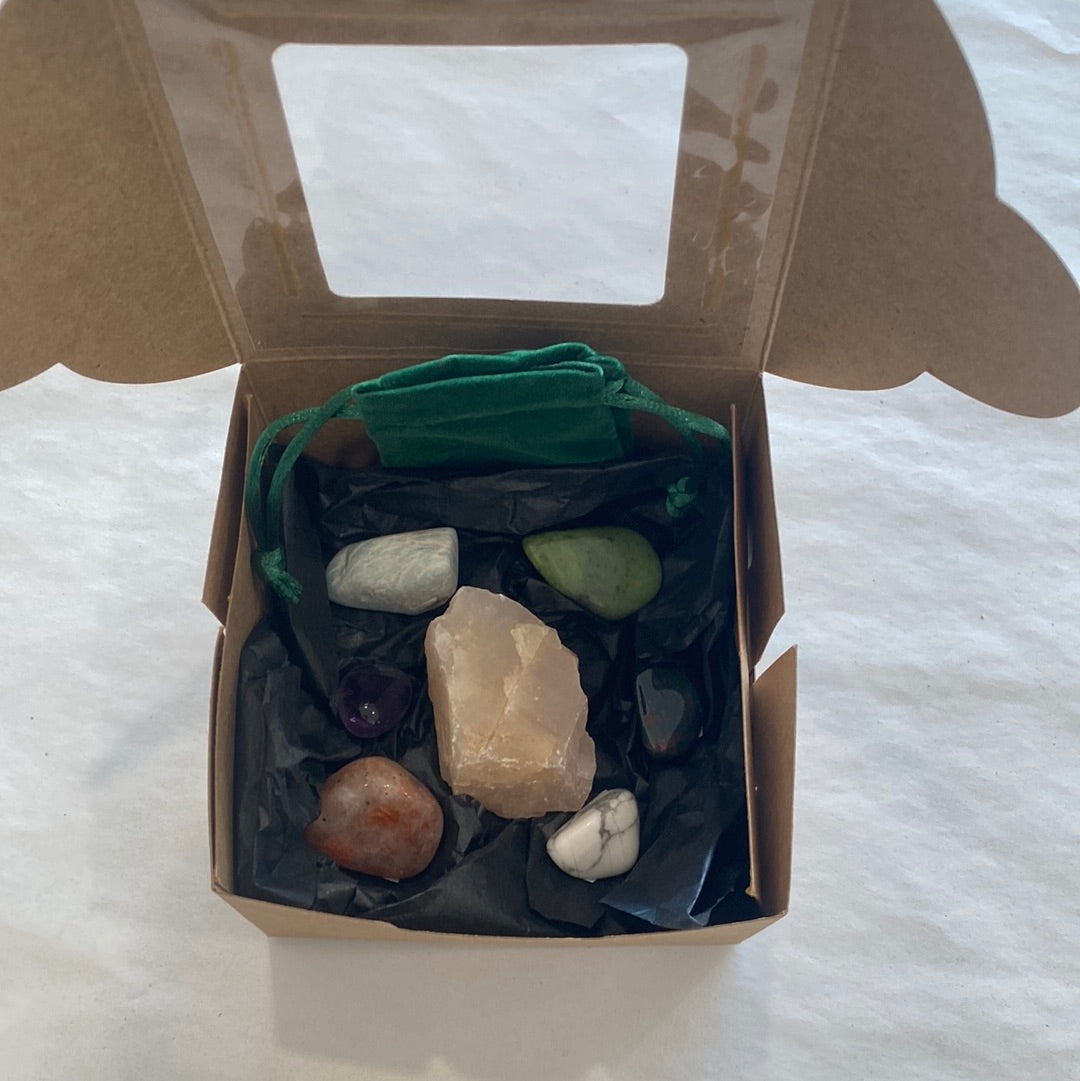 Chill Vibes Anxiety Bundle featuring various tumbled stones including Rose Quartz, Bloodstone, Sunstone, Amethyst, Howlite, Nephrite Jade, and Amazonite, beautifully arranged.