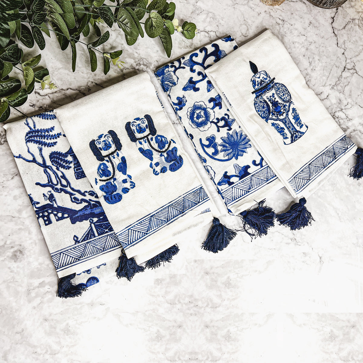 Beautiful Chinoiserie Tea Towels with blue and white embroidery and decorative tassels, showcasing their oversized design.