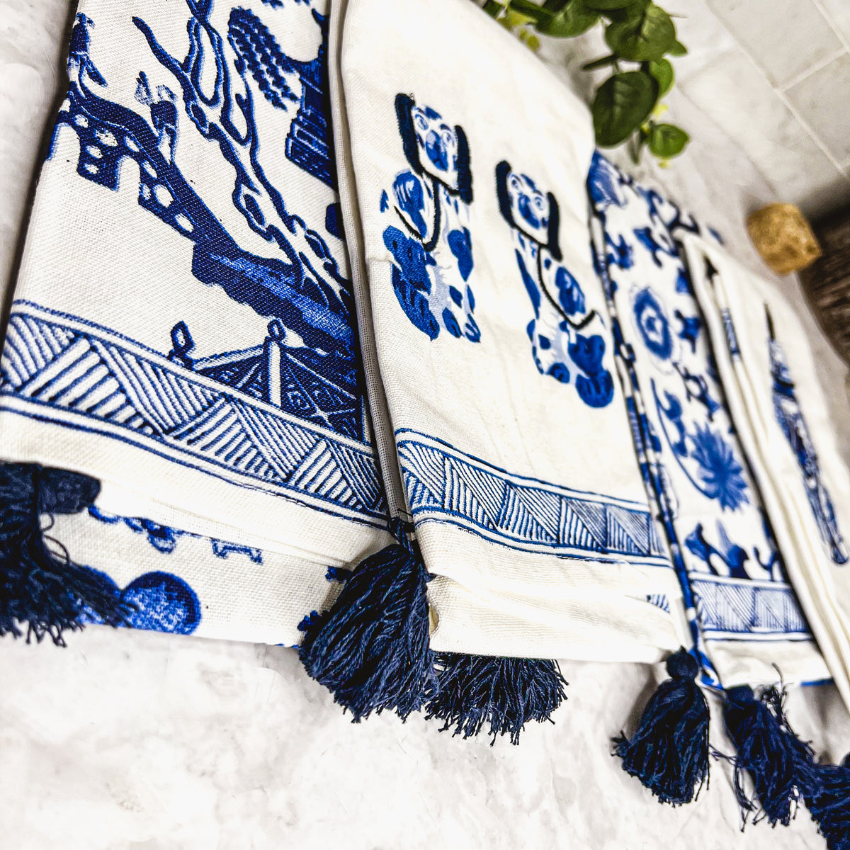 Beautiful Chinoiserie Tea Towels with blue and white embroidery and decorative tassels, showcasing their oversized design.