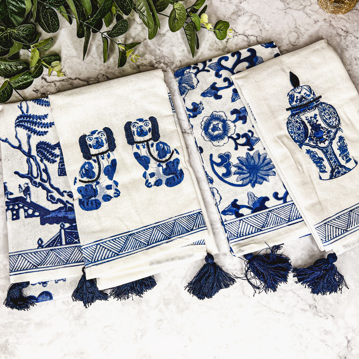 Beautiful Chinoiserie Tea Towels with blue and white embroidery and decorative tassels, showcasing their oversized design.