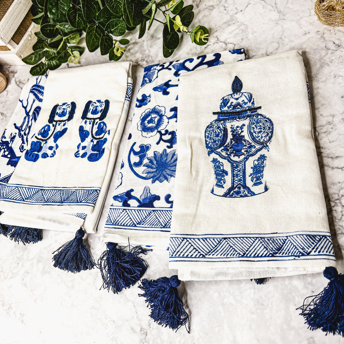 Beautiful Chinoiserie Tea Towels with blue and white embroidery and decorative tassels, showcasing their oversized design.