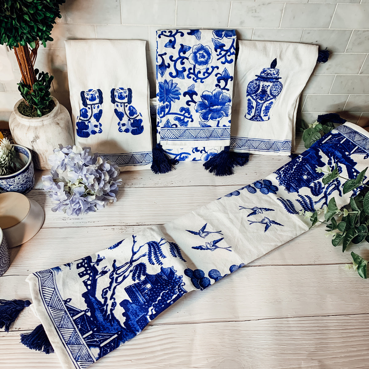 Beautiful Chinoiserie Tea Towels with blue and white embroidery and decorative tassels, showcasing their oversized design.