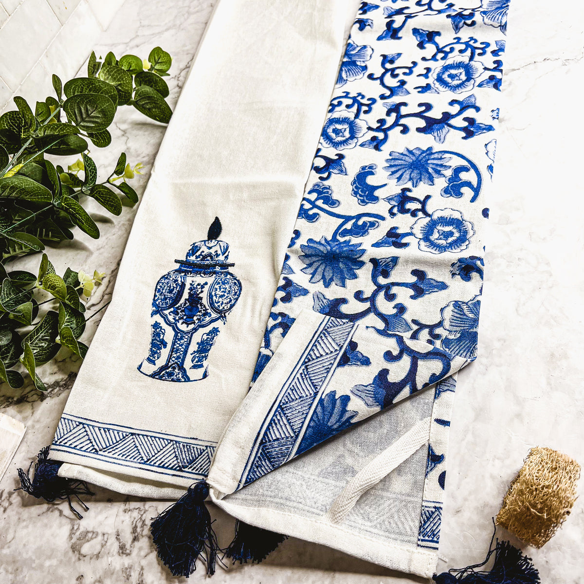 Beautiful Chinoiserie Tea Towels with blue and white embroidery and decorative tassels, showcasing their oversized design.