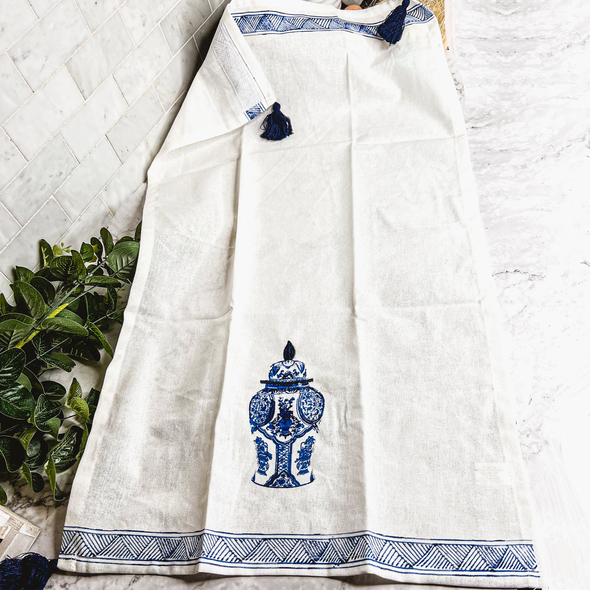 Beautiful Chinoiserie Tea Towels with blue and white embroidery and decorative tassels, showcasing their oversized design.