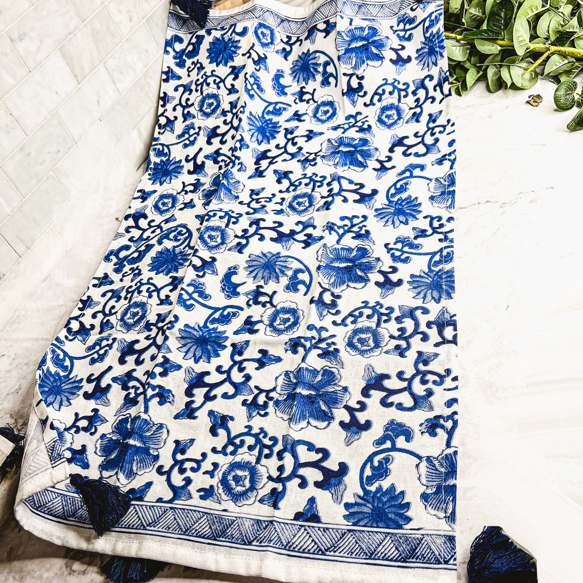 Beautiful Chinoiserie Tea Towels with blue and white embroidery and decorative tassels, showcasing their oversized design.