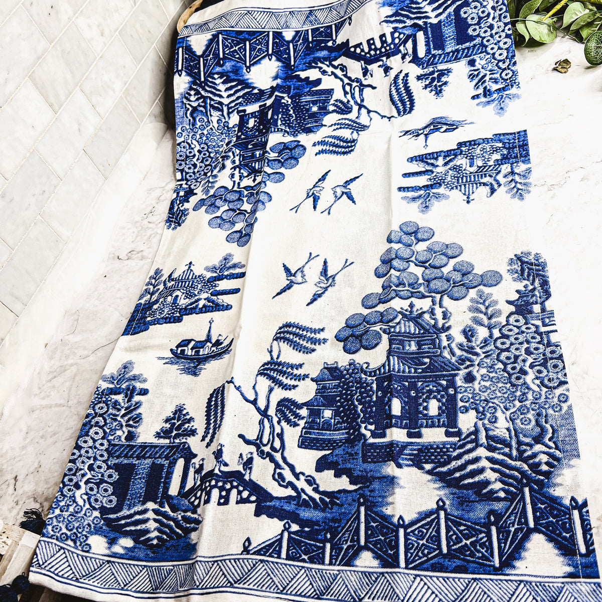 Beautiful Chinoiserie Tea Towels with blue and white embroidery and decorative tassels, showcasing their oversized design.