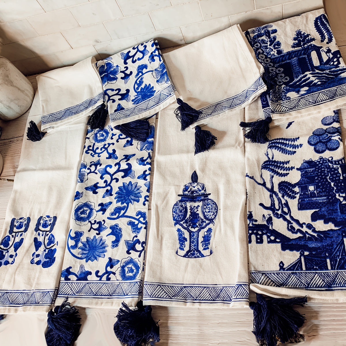 Beautiful Chinoiserie Tea Towels with blue and white embroidery and decorative tassels, showcasing their oversized design.