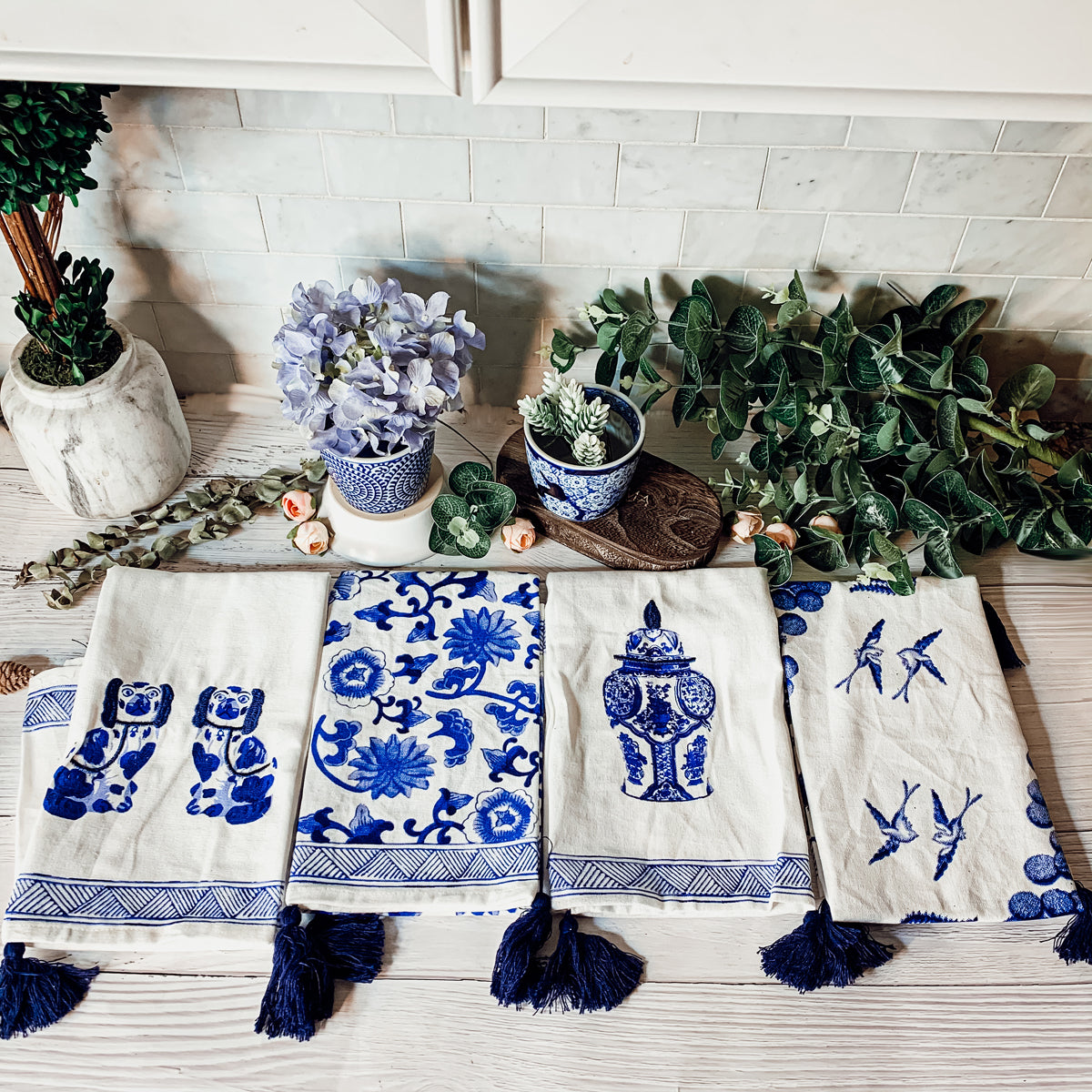 Beautiful Chinoiserie Tea Towels with blue and white embroidery and decorative tassels, showcasing their oversized design.