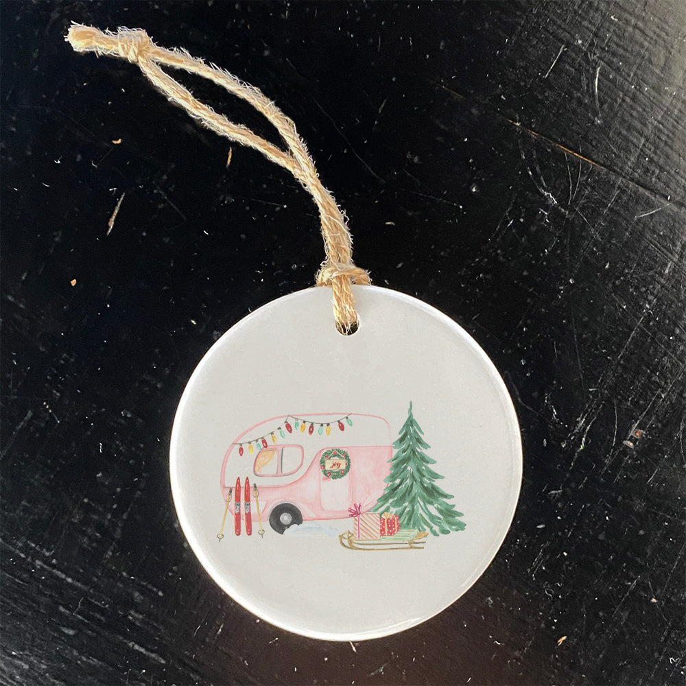 A beautifully crafted porcelain Christmas Camper ornament featuring vibrant colors and a glossy finish, perfect for holiday decor.