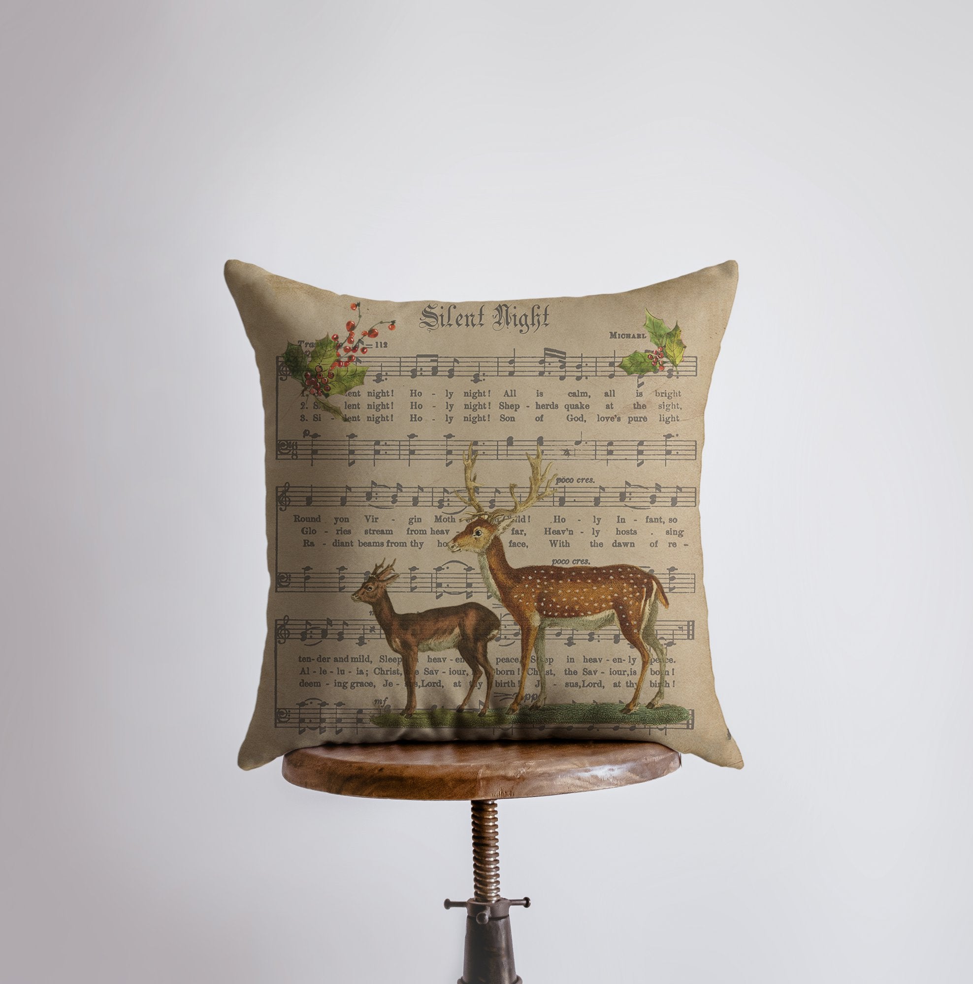 Rustic Silent Night Pillow featuring sheet music design with deer and holly branches, handmade in America.