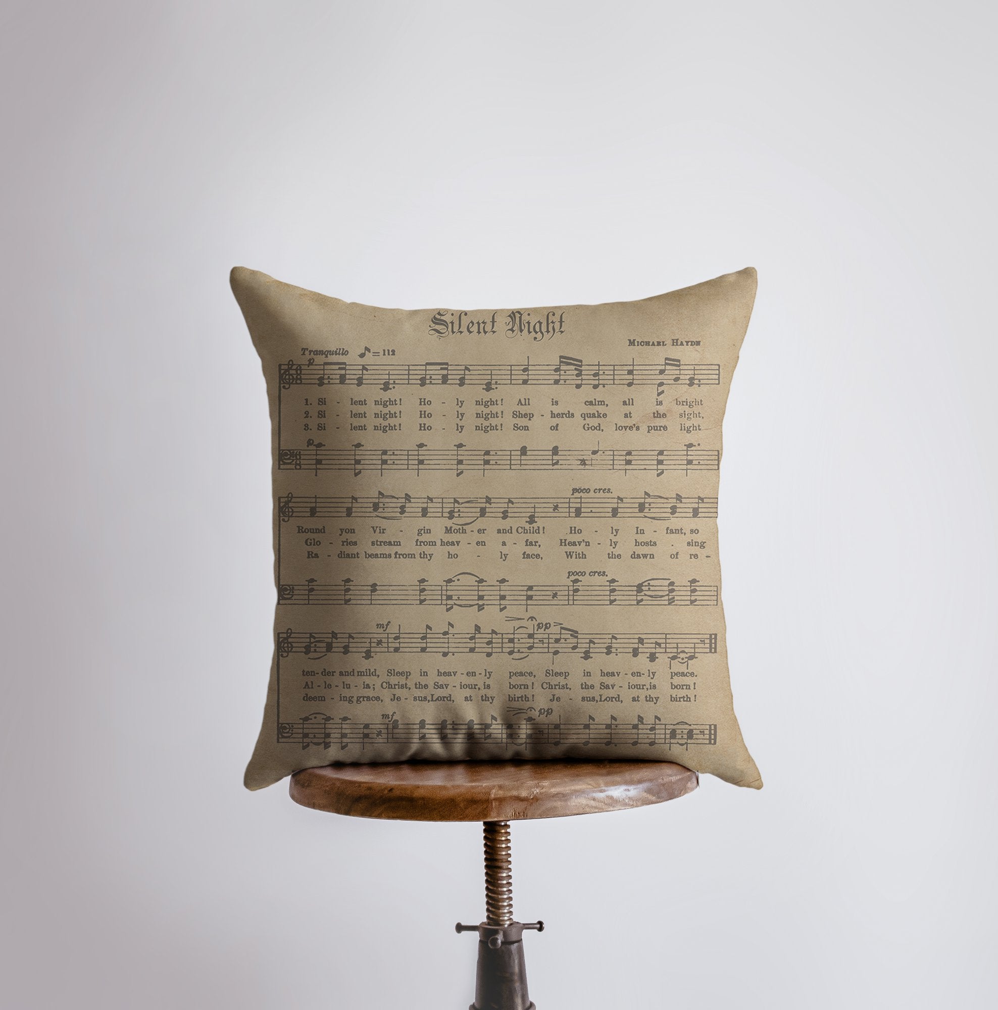 Rustic Silent Night Pillow featuring sheet music design with deer and holly branches, handmade in America.