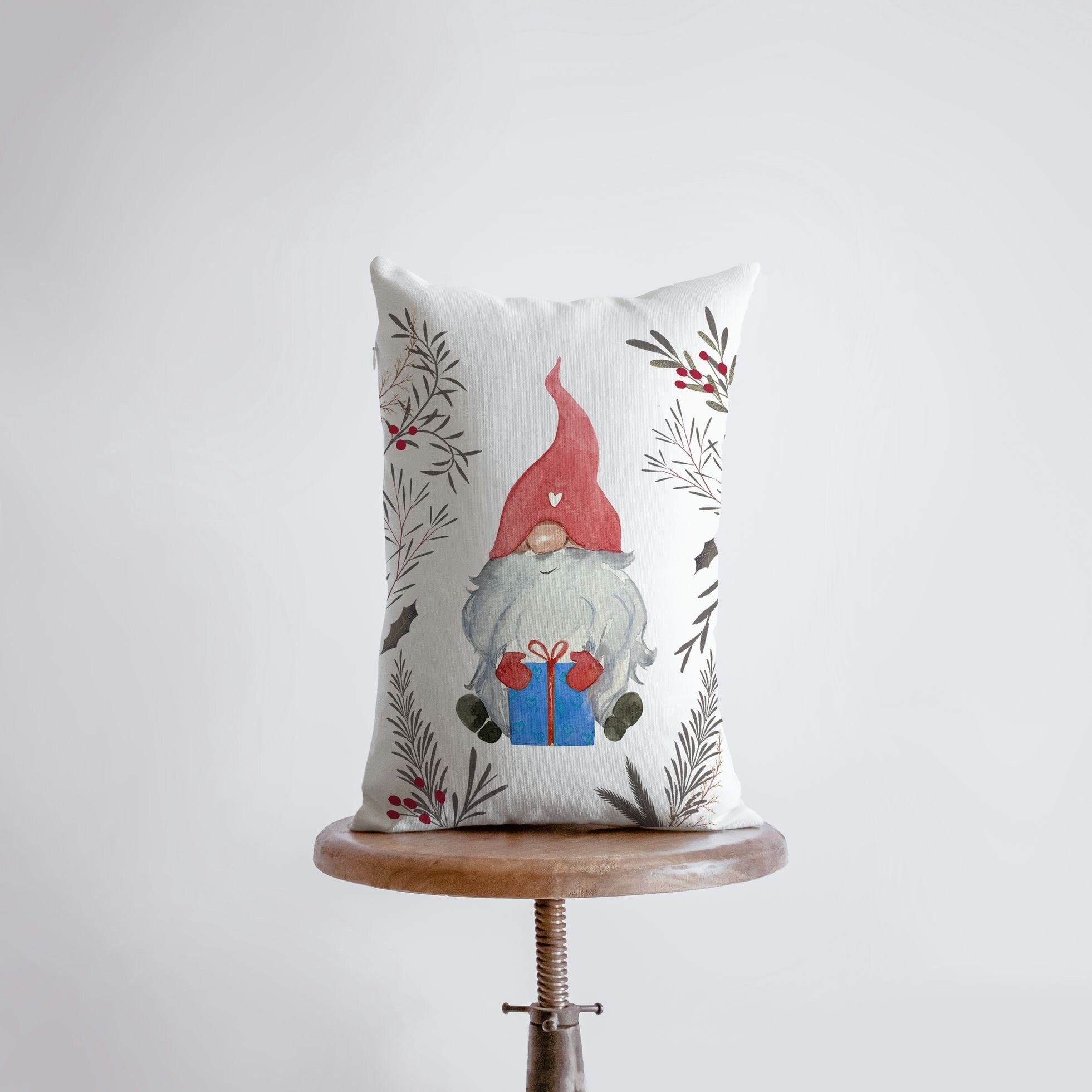 Christmas Gnome throw pillow featuring a watercolor gnome with a red hat surrounded by leaves and berries, perfect for holiday decor.