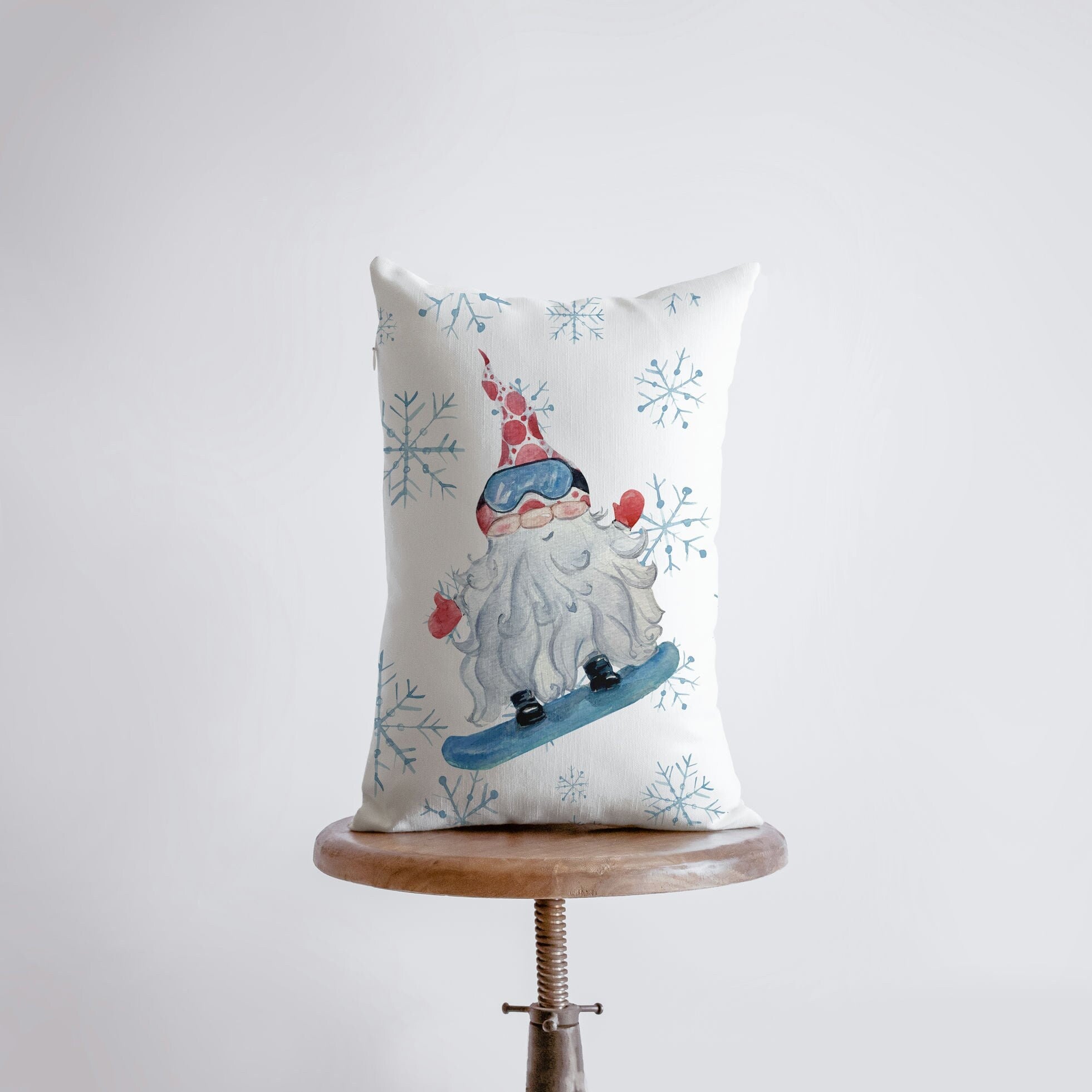 Christmas Gnome Snowboarding throw pillow with snowflakes, hand-made in America, featuring a whimsical gnome design.