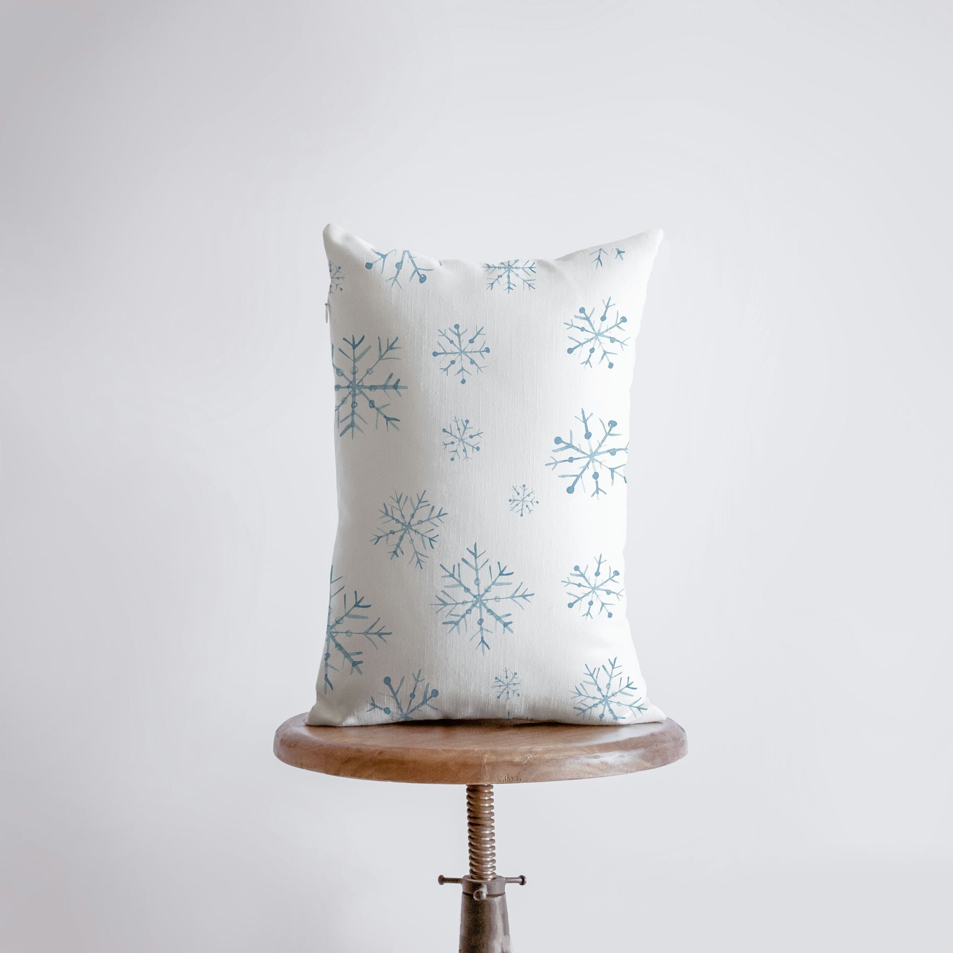 Christmas Gnome Snowboarding throw pillow with snowflakes, hand-made in America, featuring a whimsical gnome design.