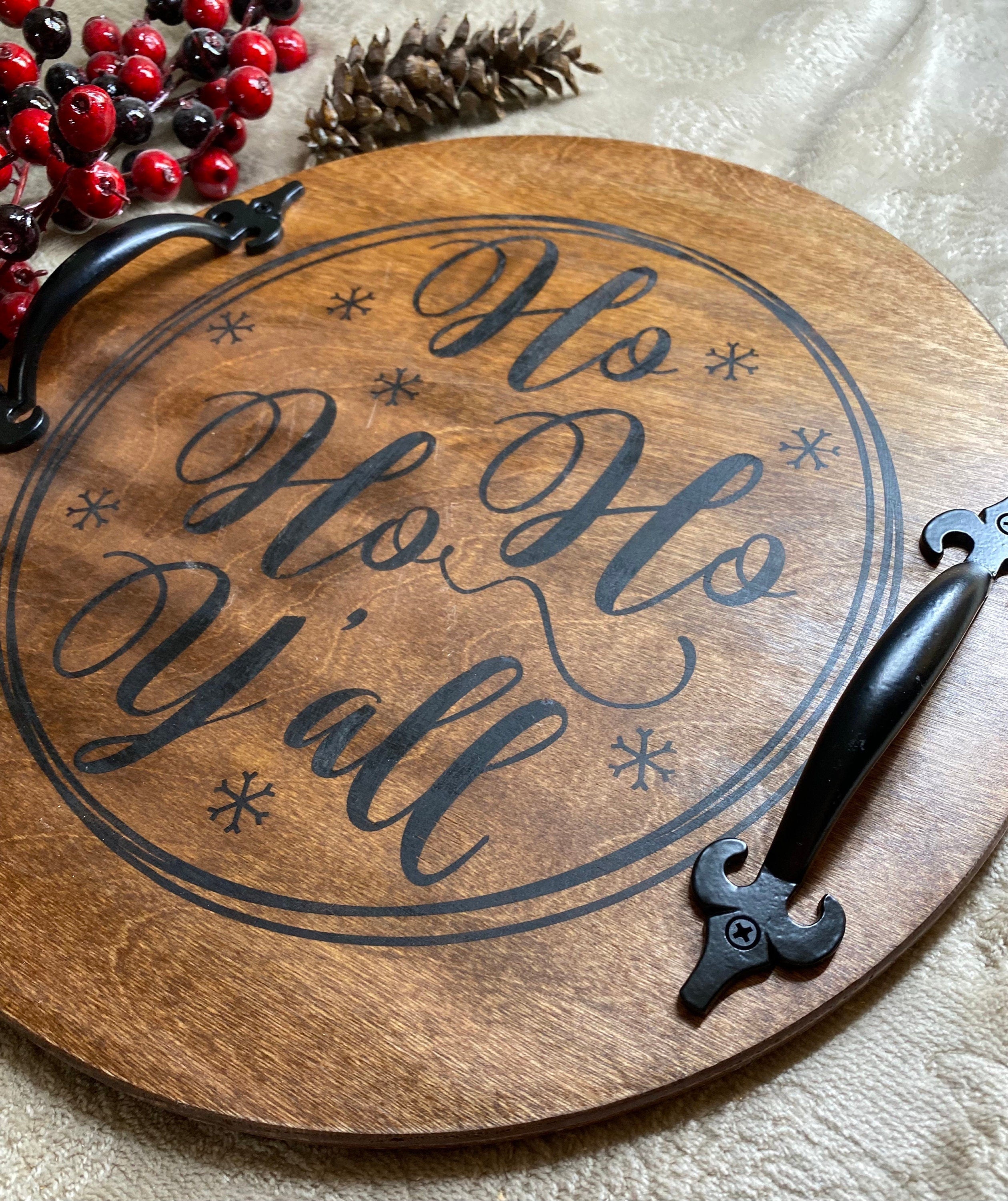 Handmade wooden Christmas serving tray with black metal handles, stained in rich chestnut color, showcasing unique wood grain patterns.