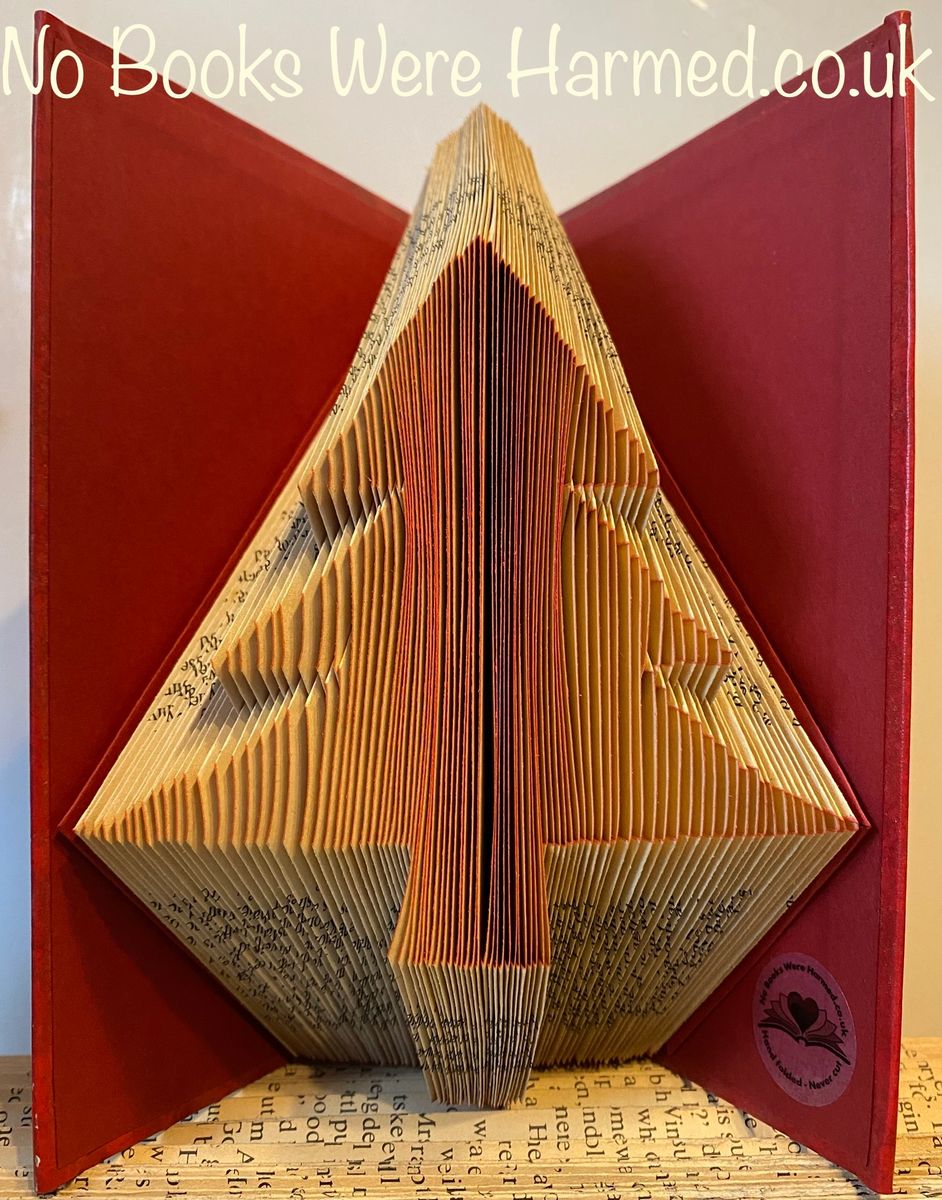 Handcrafted Christmas Tree art made from vintage books, showcasing unique folds and textures.