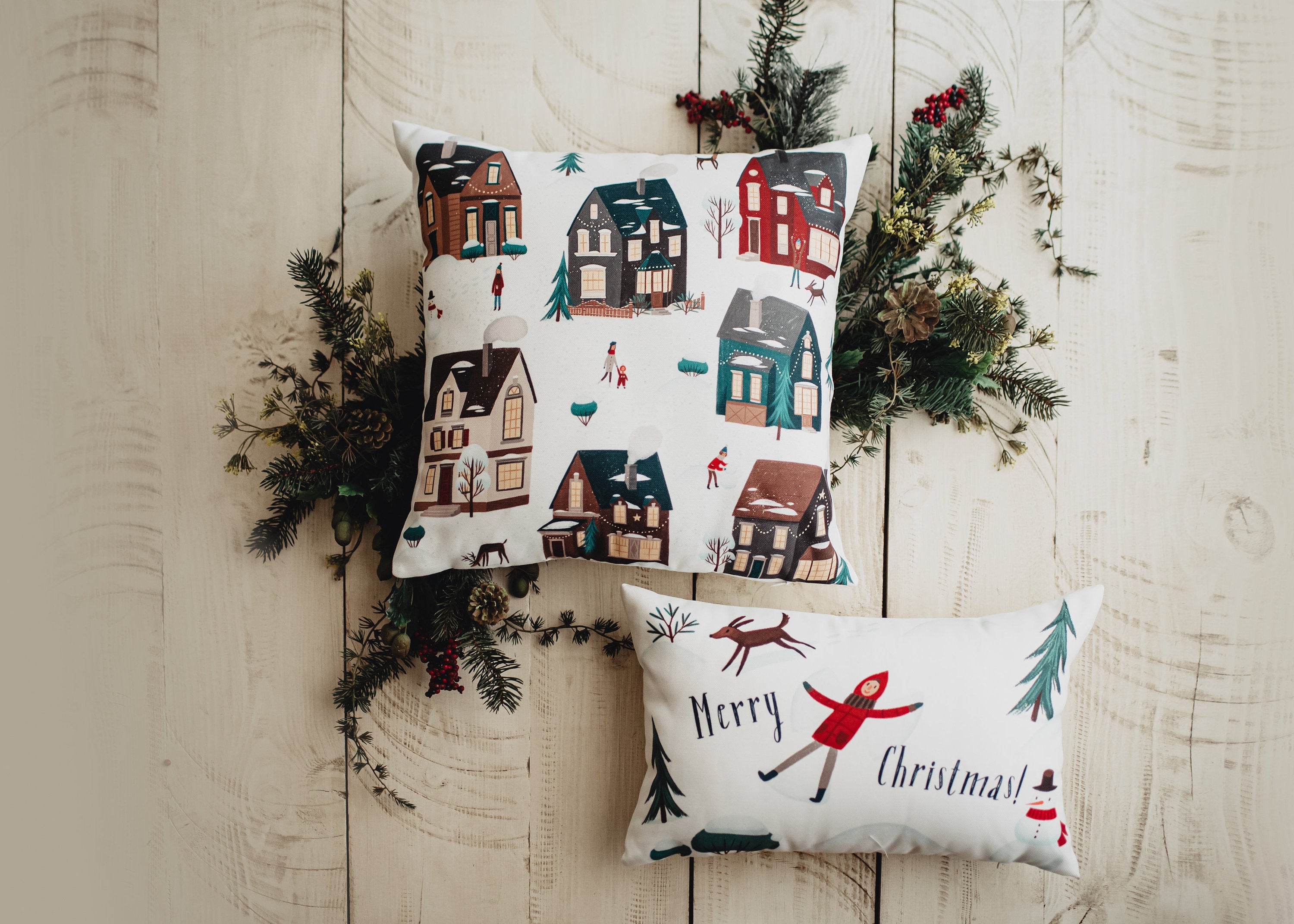 Christmas Village Houses Throw Pillow Cover featuring a snowy village scene with houses and neighbors, made in America.