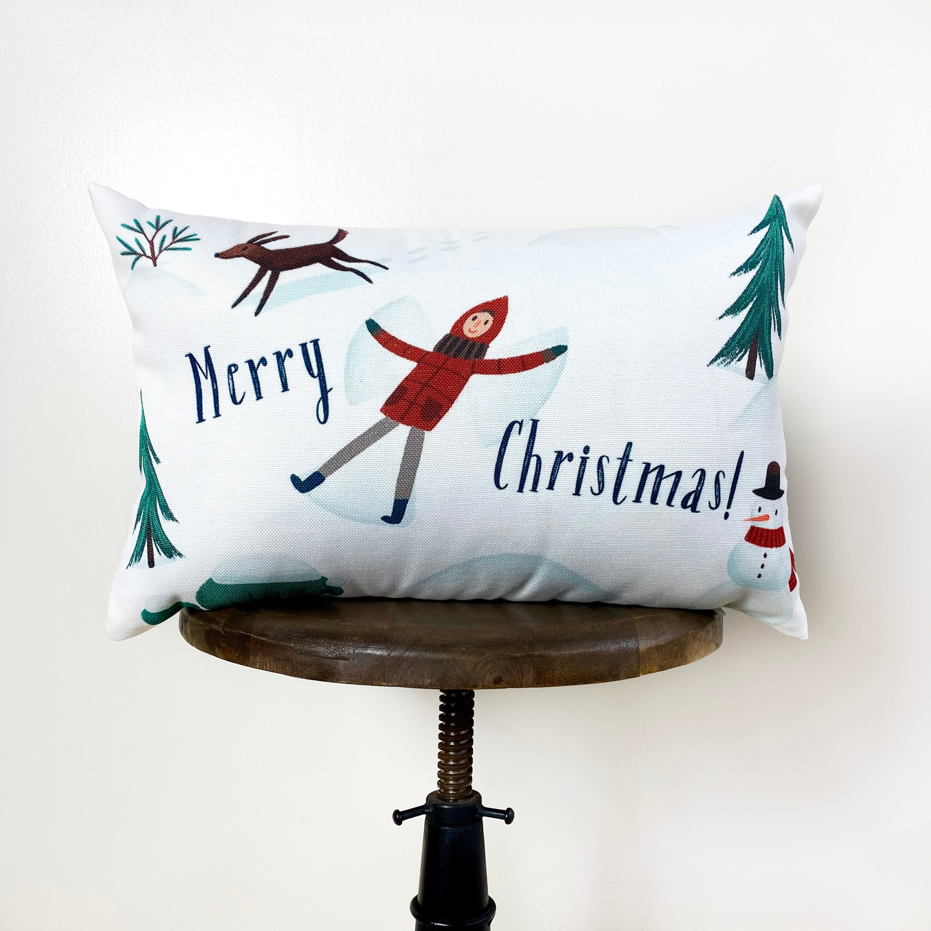 Christmas Village Houses Throw Pillow Cover featuring a snowy village scene with houses and neighbors, made in America.