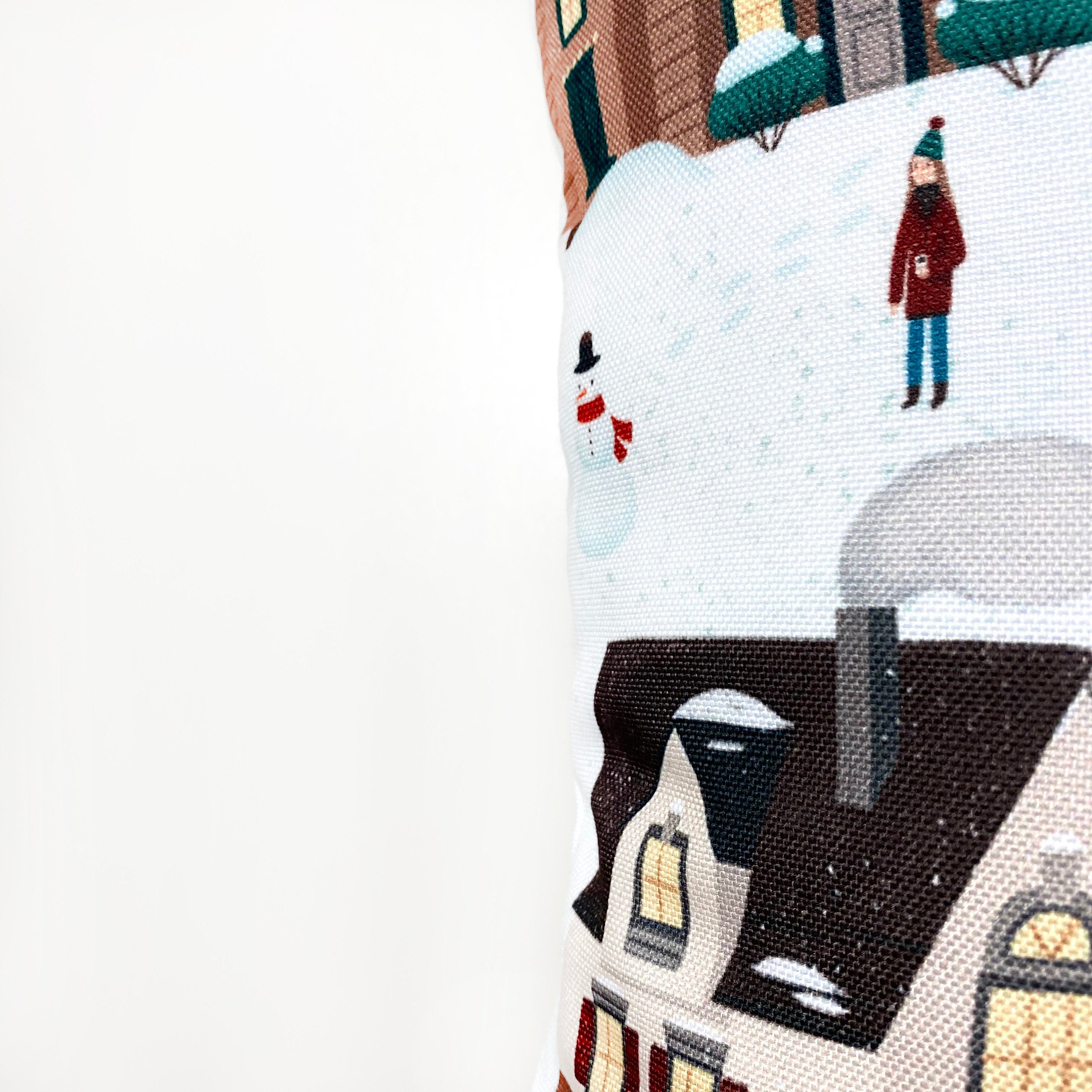 Christmas Village Houses Throw Pillow Cover featuring a snowy village scene with houses and neighbors, made in America.