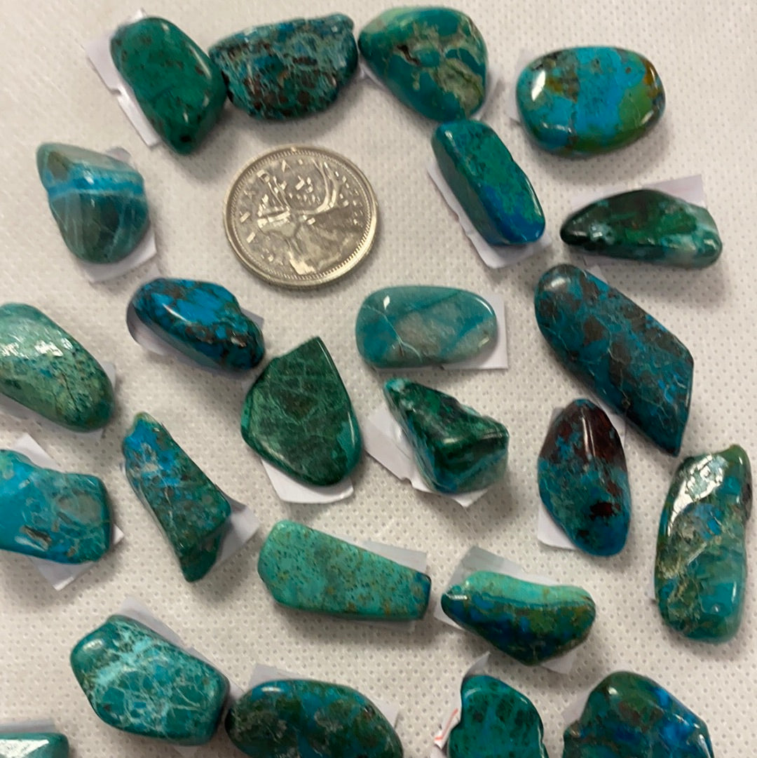 A collection of beautiful Chrysocolla tumbled stones in various shades of blue and green, showcasing their smooth, polished surfaces.