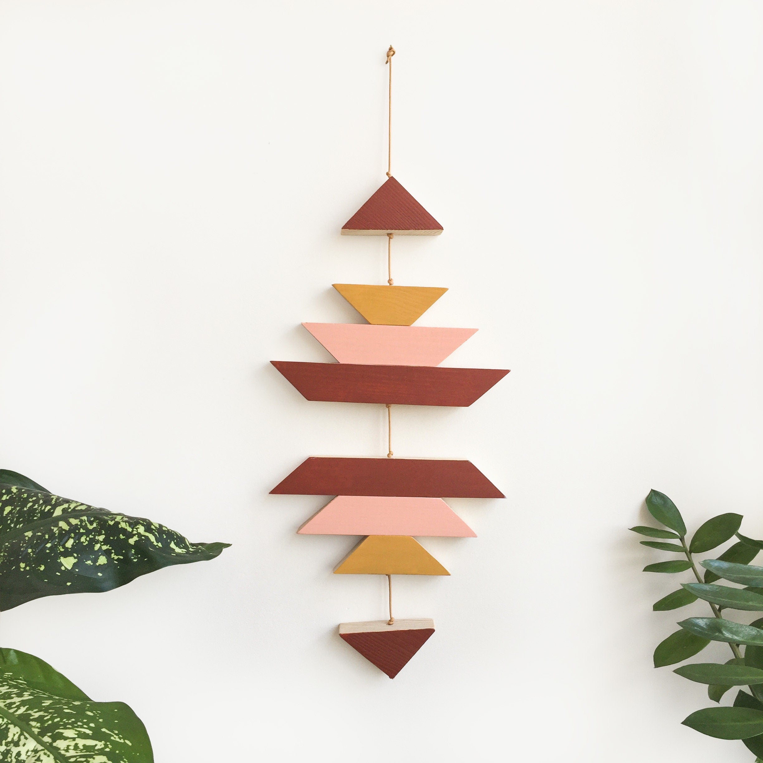 Cinnamon small wood wall hanging featuring geometric design, hand-painted with eco-friendly paints, connected with cream cotton cord.